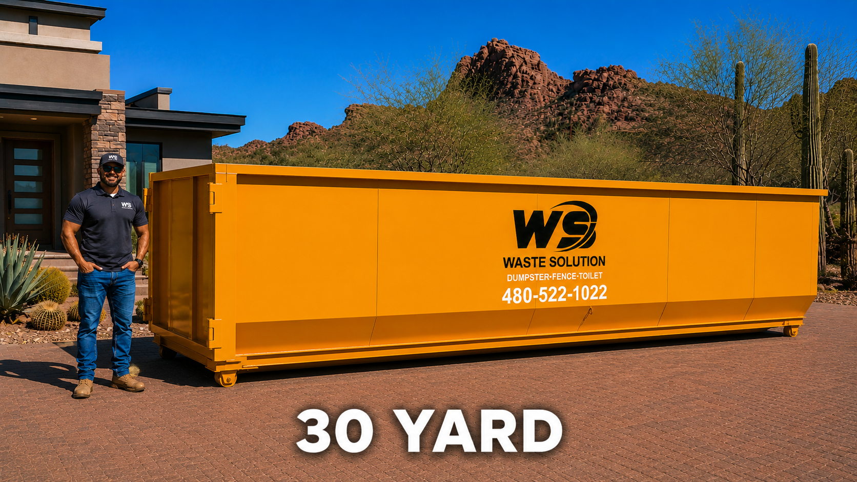 A man in a navy blue uniform standing next to a large yellow waste disposal container with the logo 'WASTE SOLUTION' and contact number '480-522-1022'. The container is labeled for dumpster, fence, and toilet waste. The setting is outdoors with desert plants and mountains in the background, under a clear blue sky.
