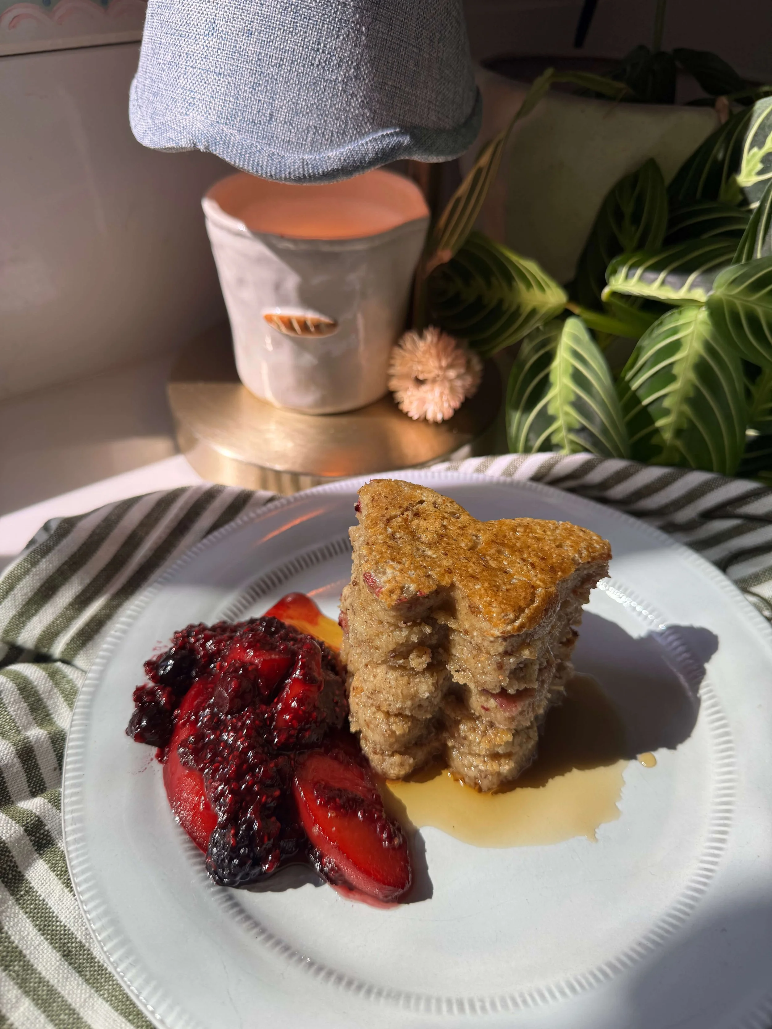 These Nourishing Protein Labor Pancakes are soft blender pancakes made with oat flour, yogurt, flax, maple syrup, and raspberry chia jam for labor prep and postpartum nourishment plate berries candle