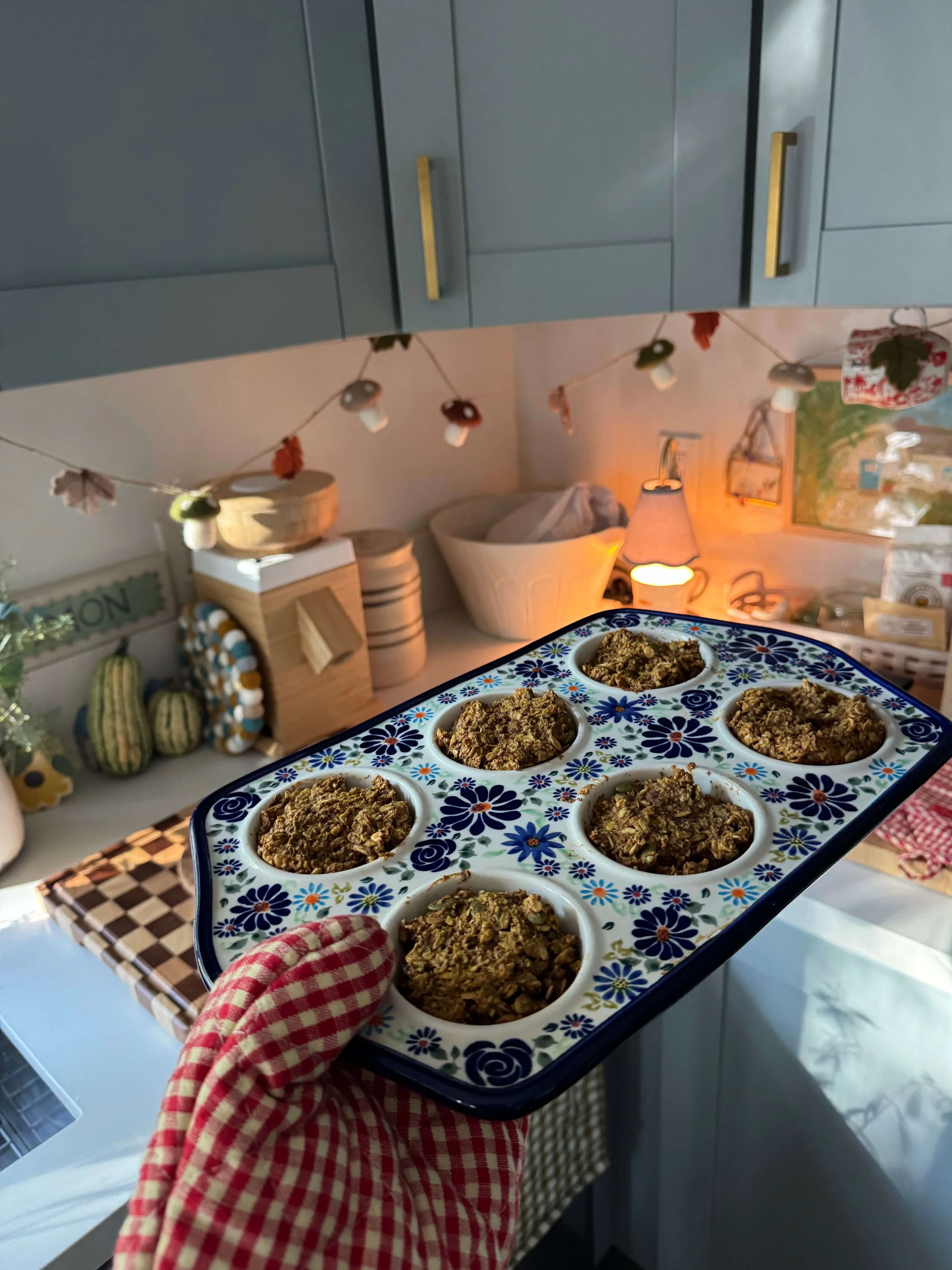 oven mit gingham holding muffins in ceramic muffin pan kitchen blue mushroom garland pumpkin muffins