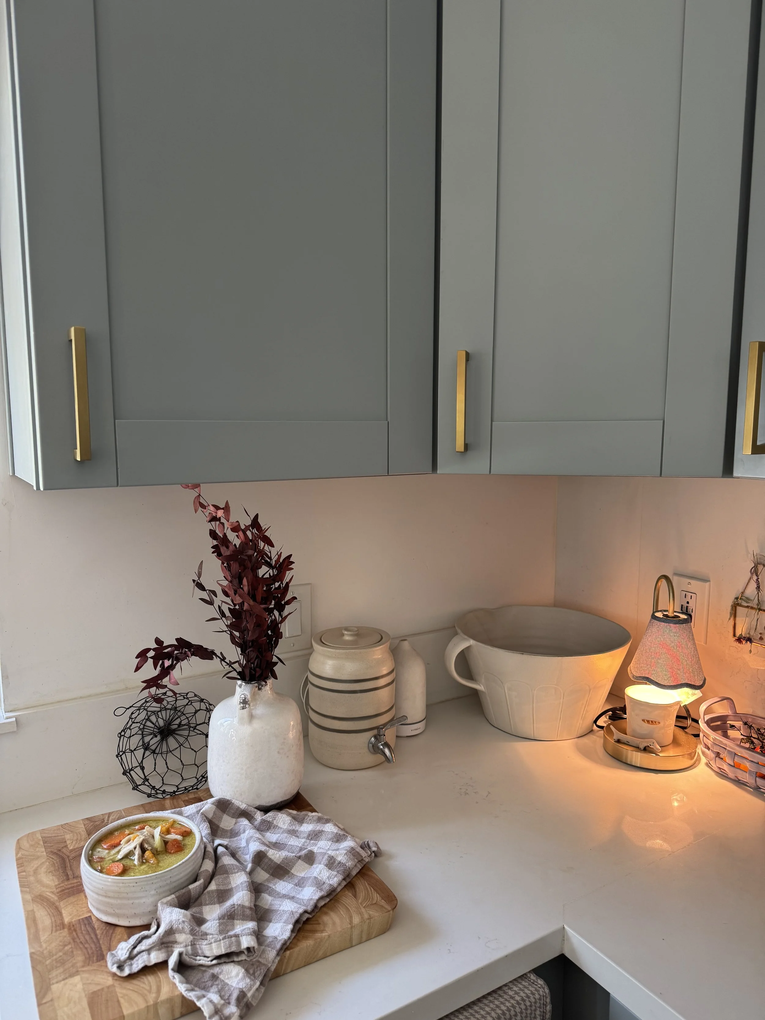 soup bowl on counter by autumn florals carrots chicken on gingham napkin