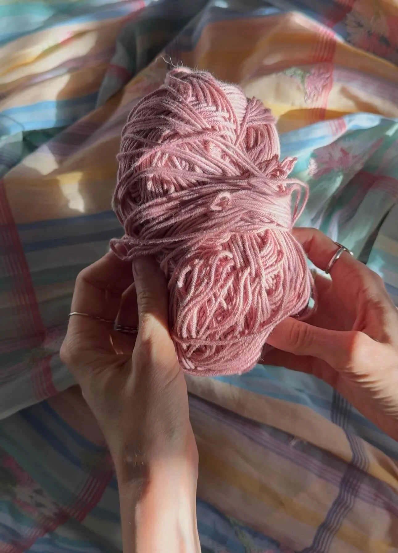 pink cotton yarn in hands