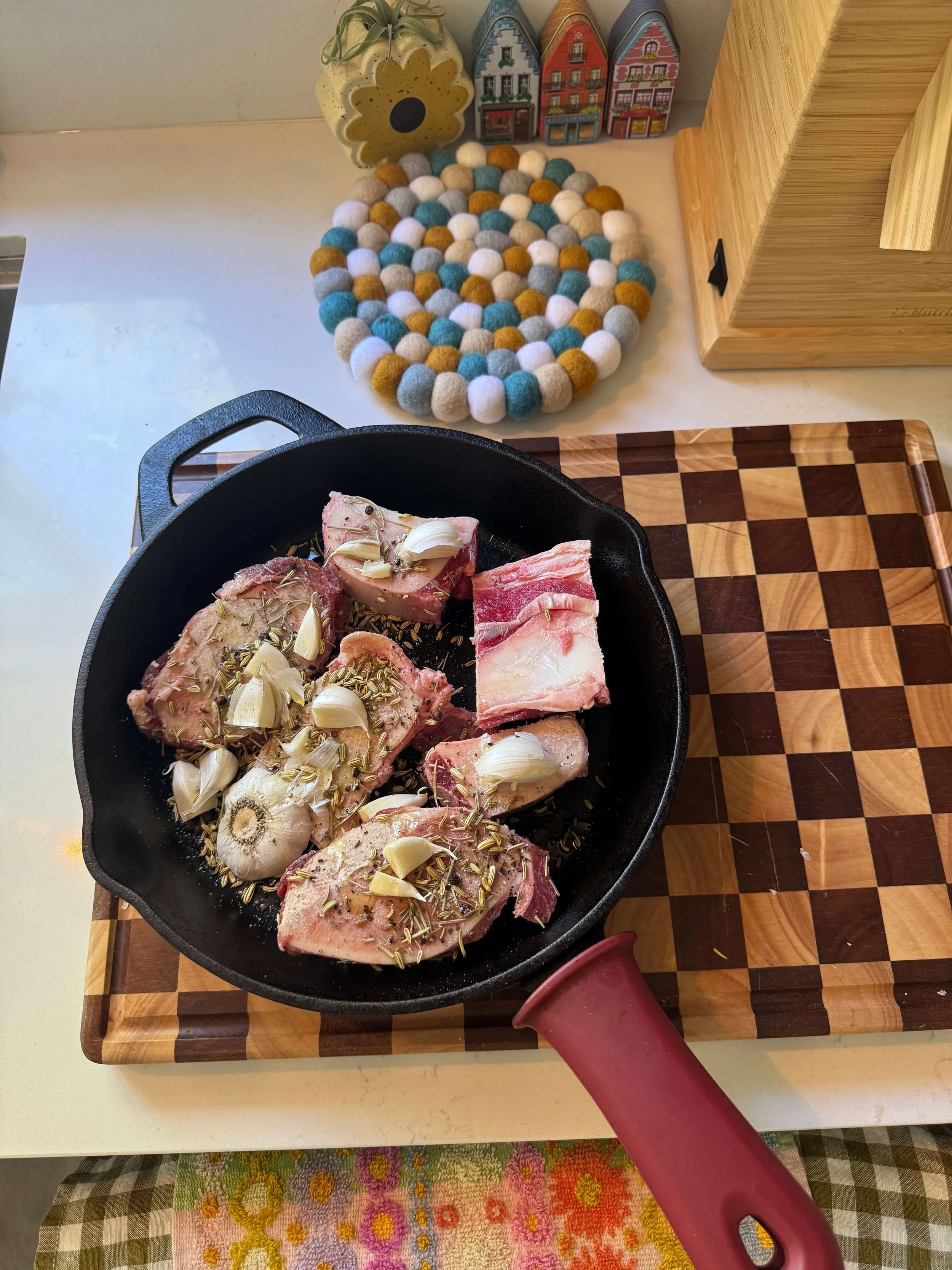 herb garlic bone marrow roasted in cast iron skillet on counter