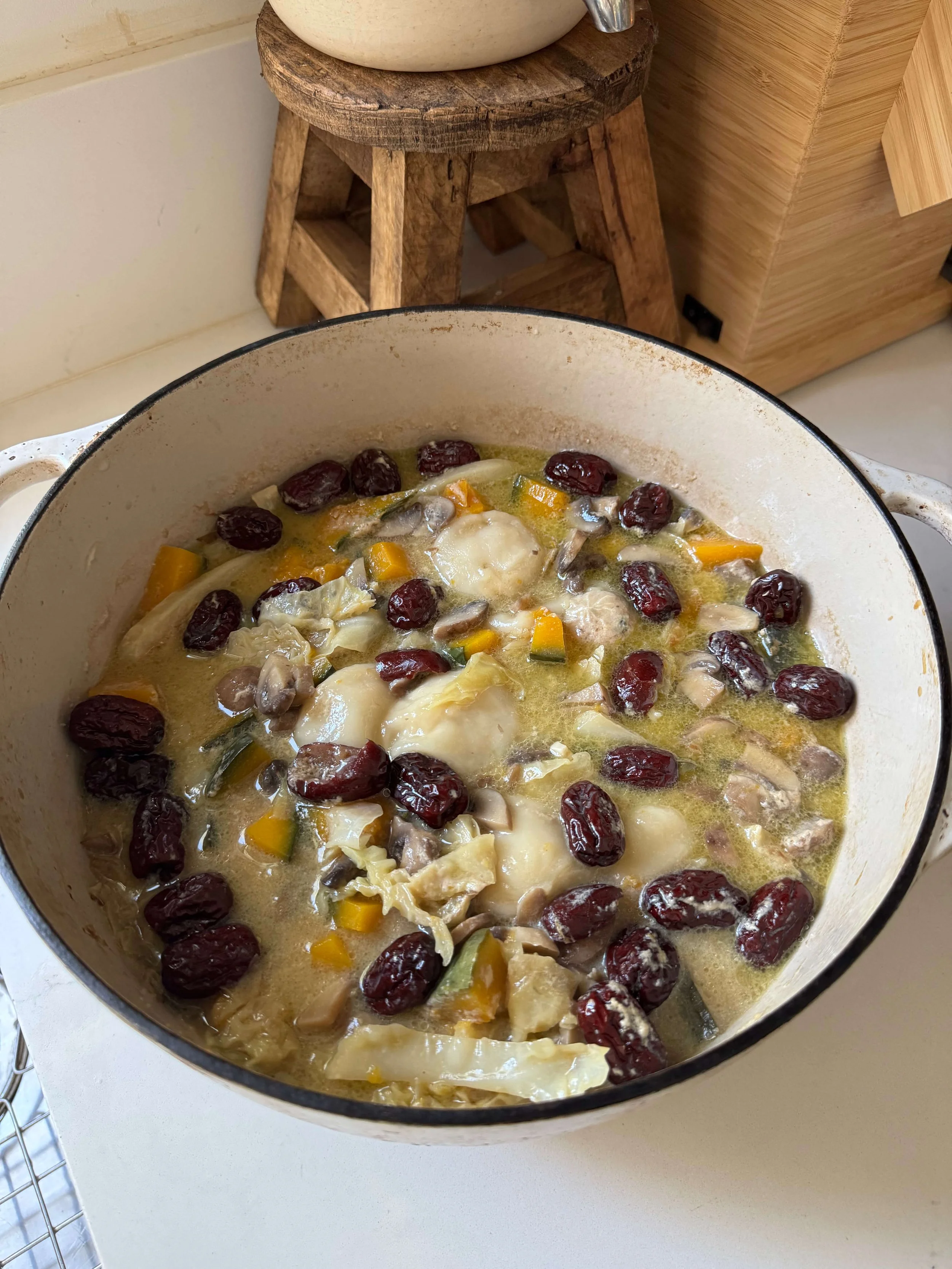 soup with jujubes on counter with squash in pot