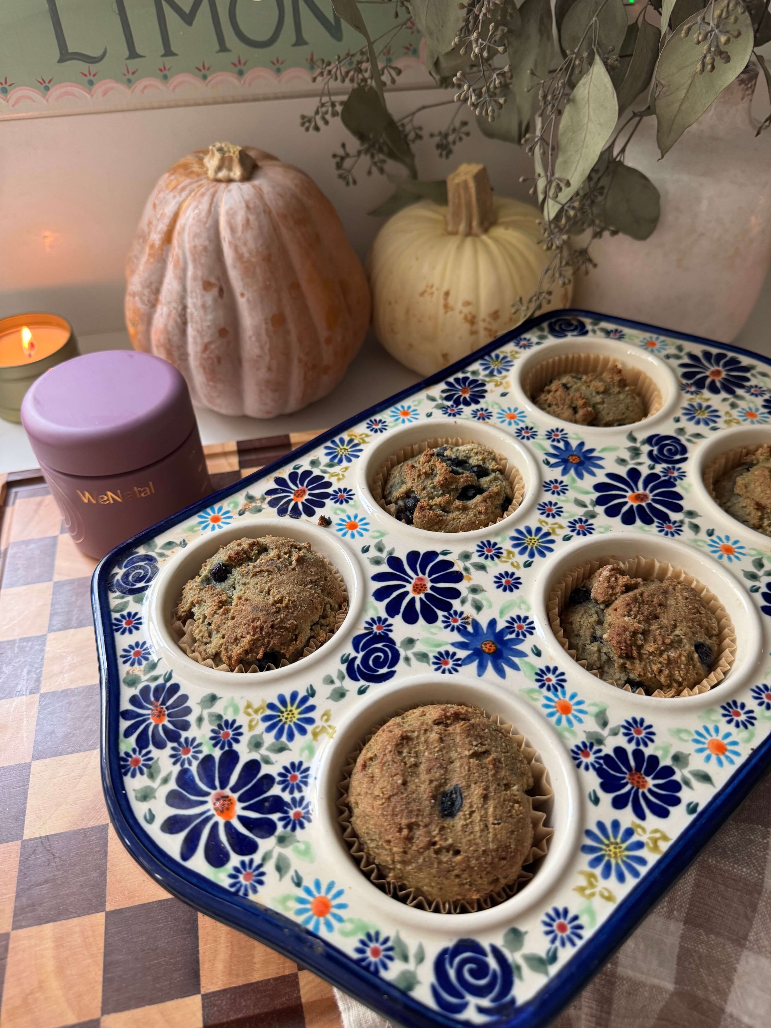 wenatal supplements infant of muffins in muffin pan by candle light in kitchen