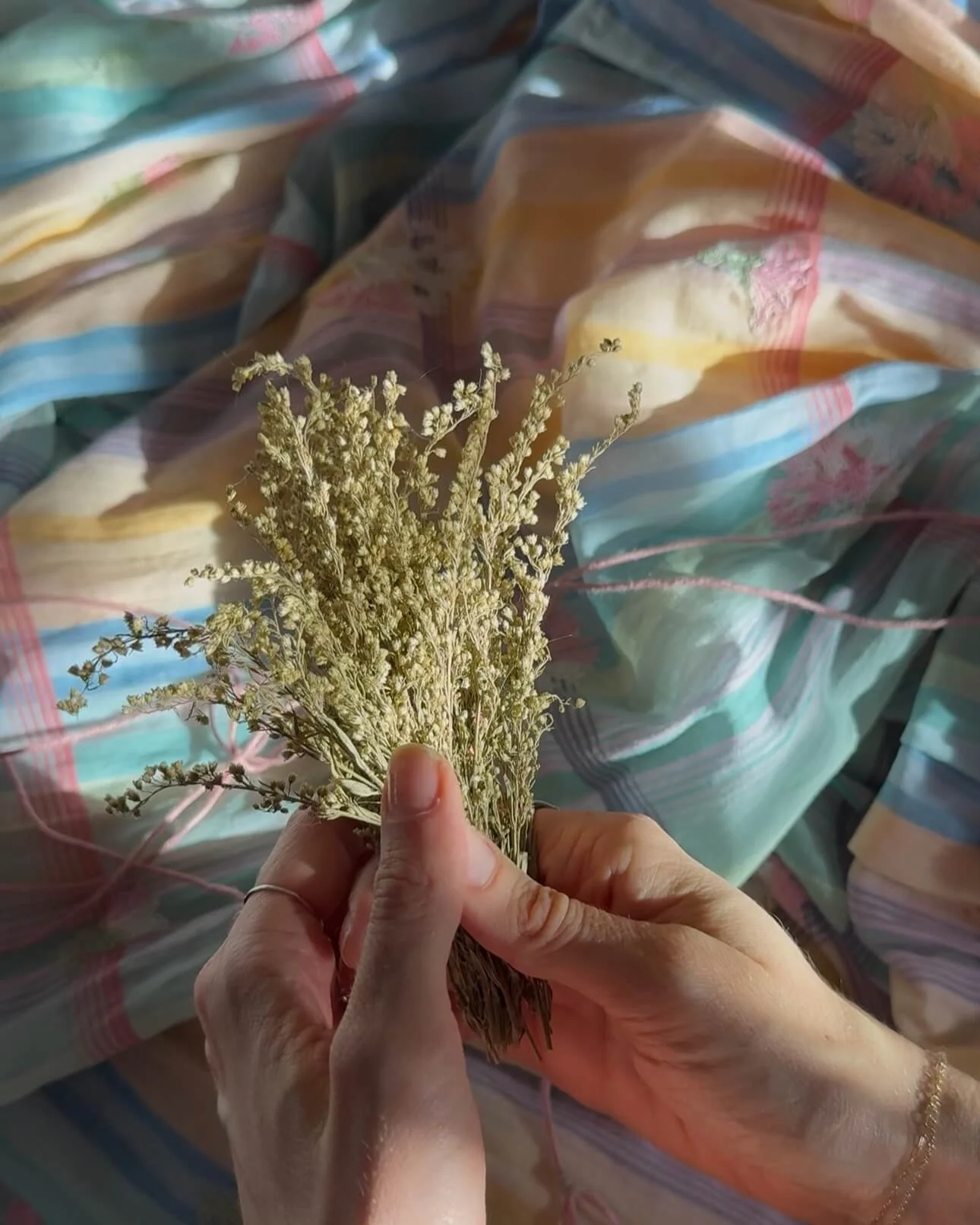 dried florals in hand for garland making