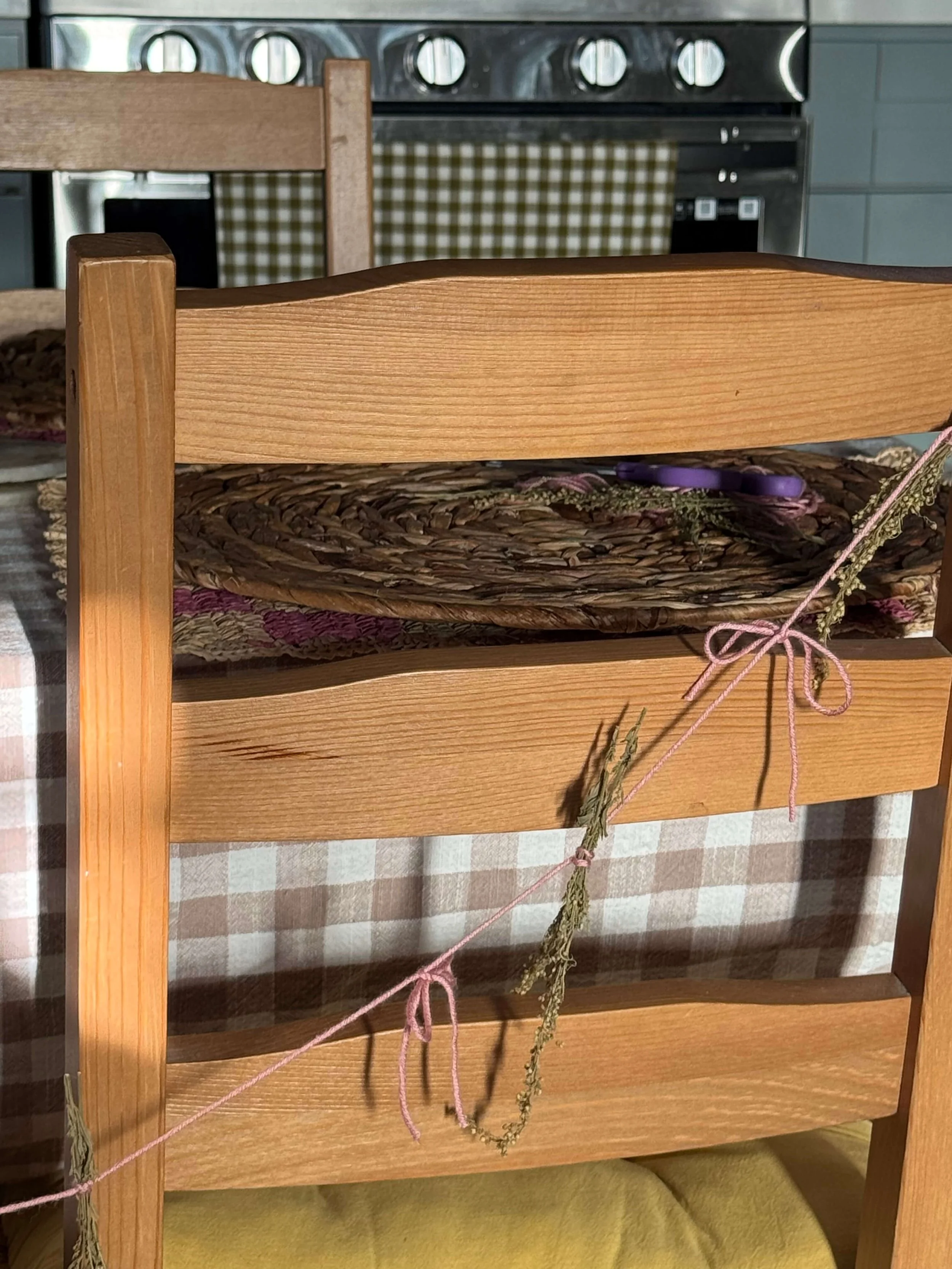 kitchen table with garland attached to chairs pink garland gender reveal yellow seat covers