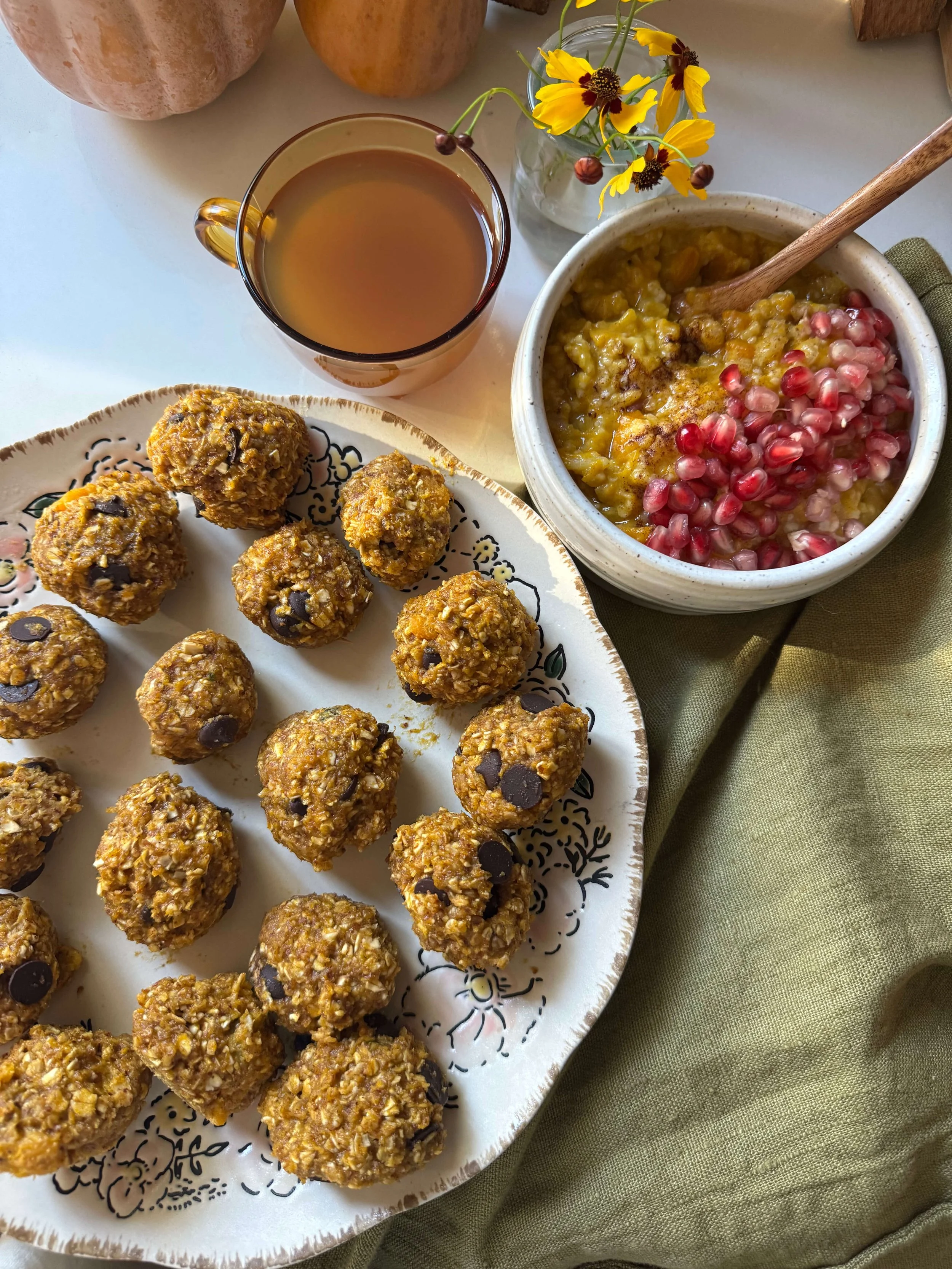 pumpkin pie spiced energy cookie bites on counter with tea and congee