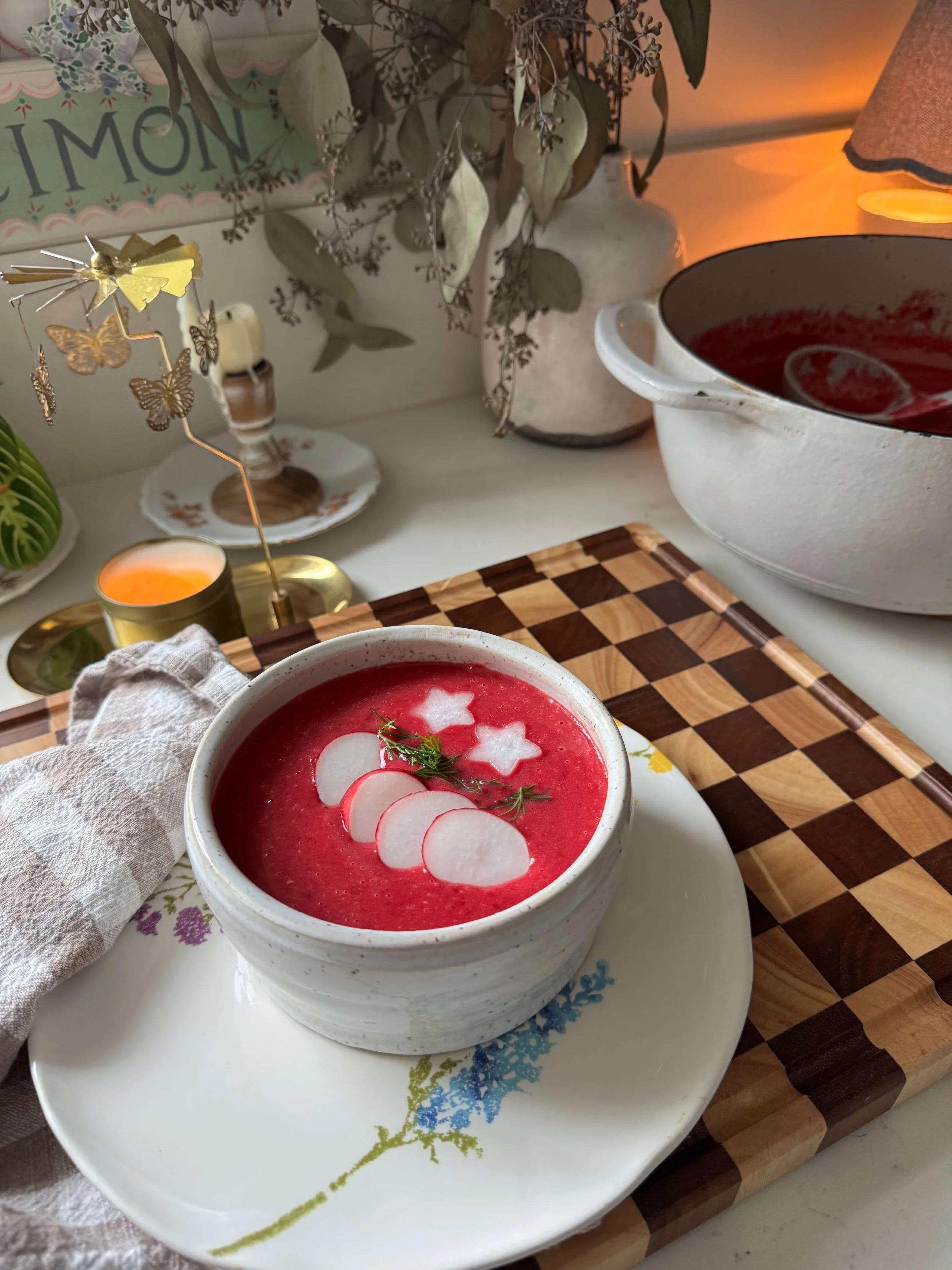 postpartum beet soup with radishes on top on plate kitchen floral