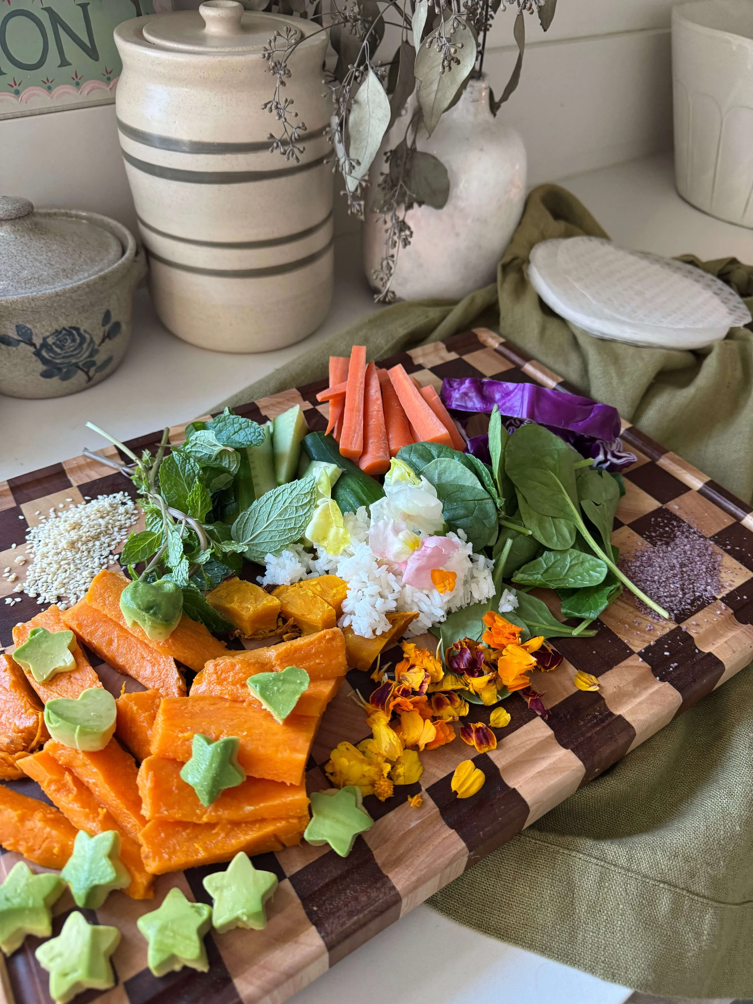 vegetables cut up on cutting board colorful on kitchen counter
