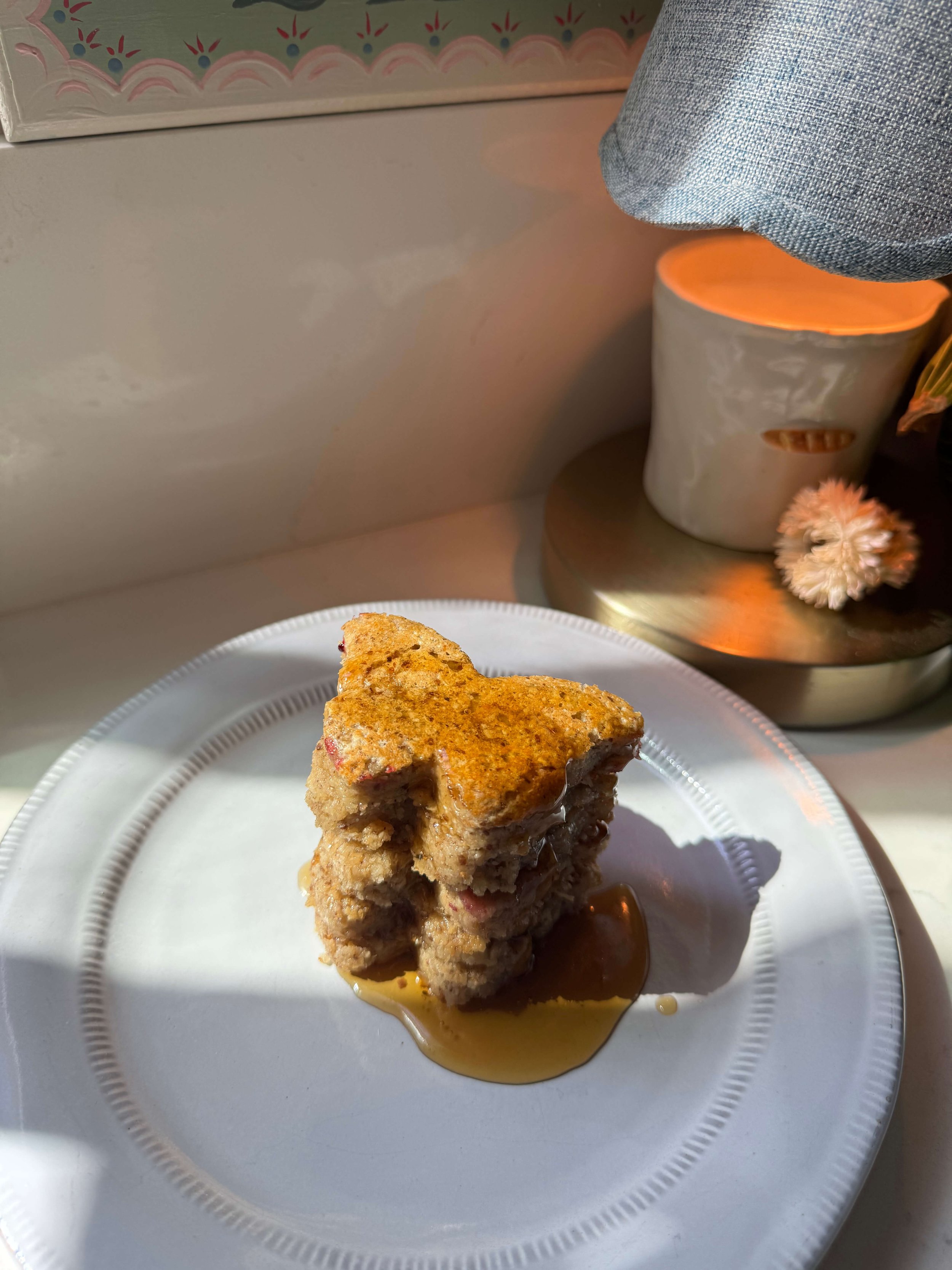 These Nourishing Protein Labor Pancakes are soft blender pancakes made with oat flour, yogurt, flax, maple syrup, and raspberry chia jam for labor prep and postpartum nourishment plate berries candle