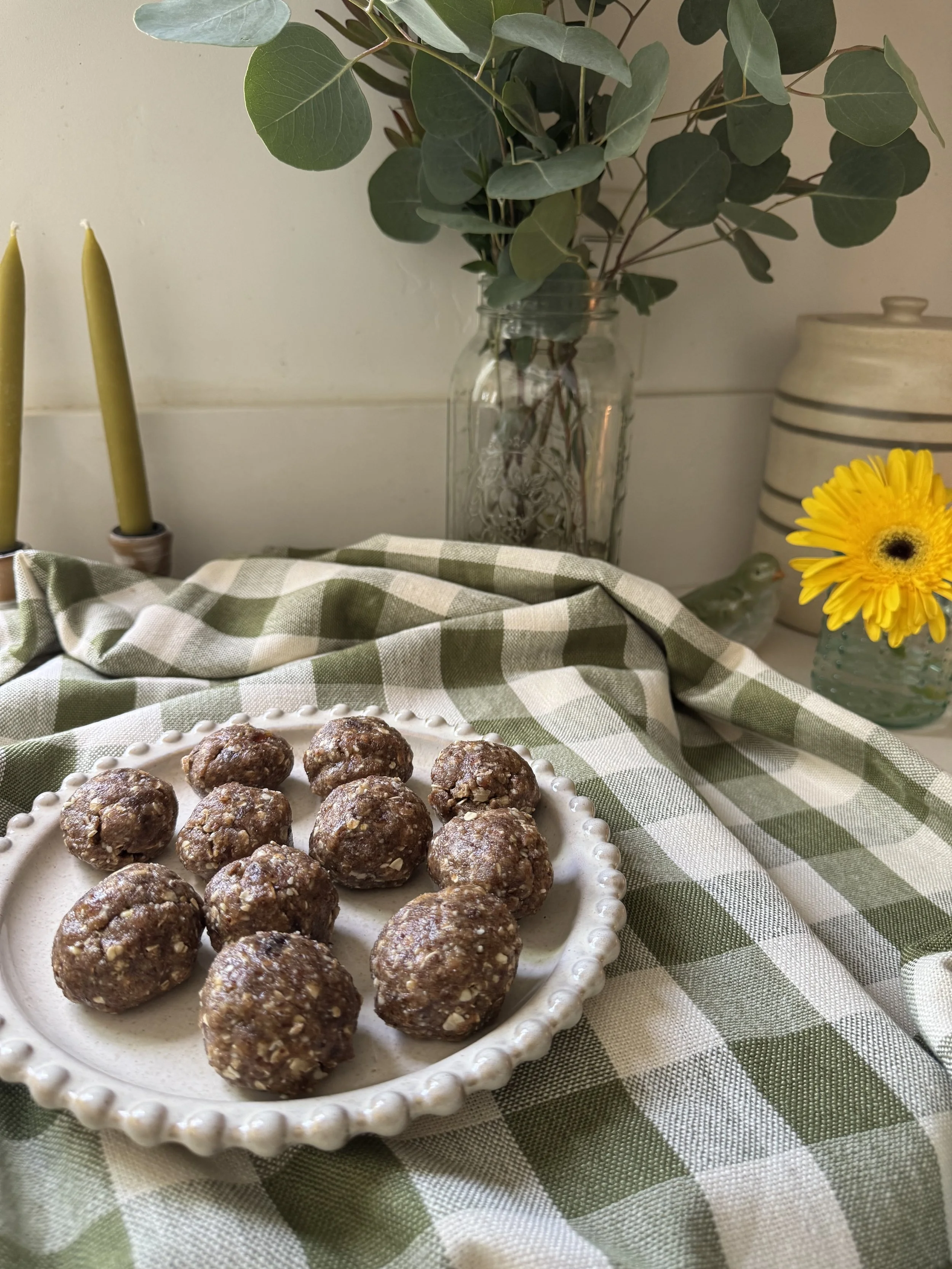 date and oat bites on gingham table cloth on plate for postpartum