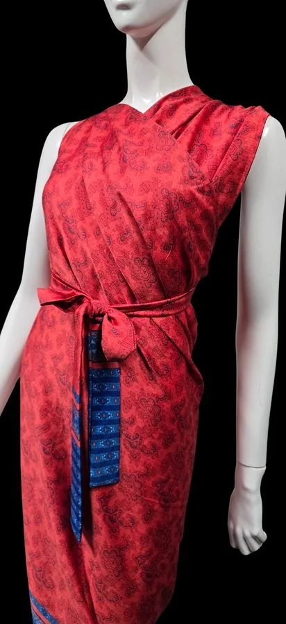 Red island-inspired resort dress with intricate tropical pattern detailing