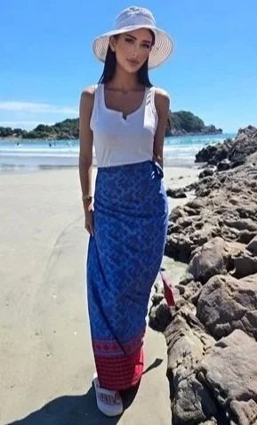 Model wearing DONBERNAE tropical wrap skirt styled for luxury island fashion