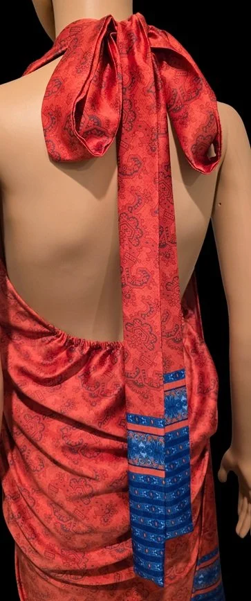Elegant red tropical wrap dress with statement bow and island-inspired details