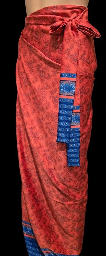 Red DONBERNAE sarong with embroidered blue island-inspired detailing