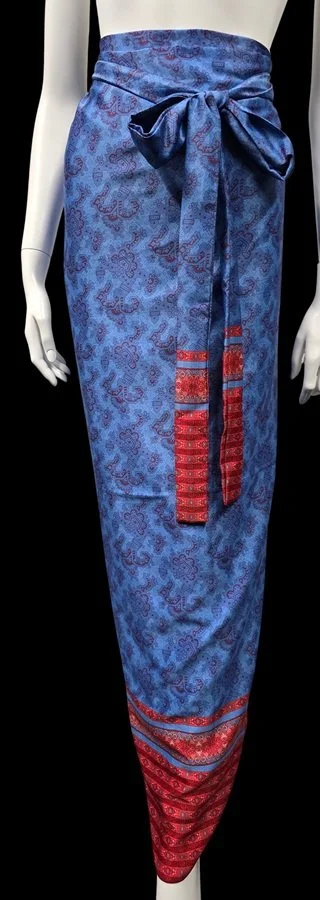 Blue and red tropical wrap sarong skirt styled for coastal resort wear

