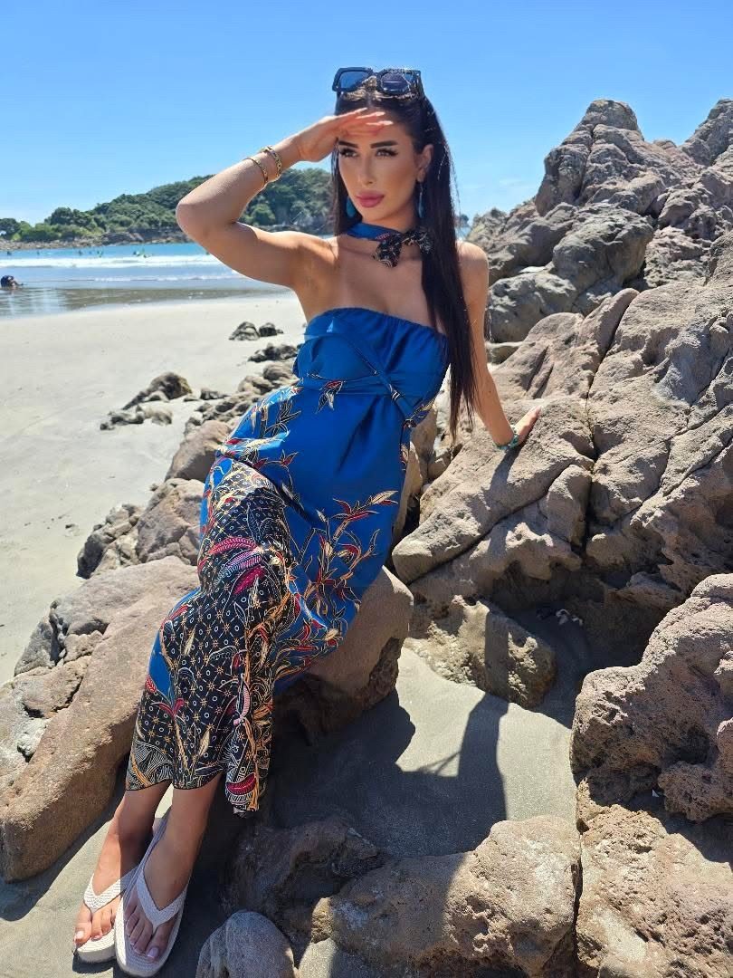 Model wearing blue DONBERNAE resort dress styled for elegant coastal living