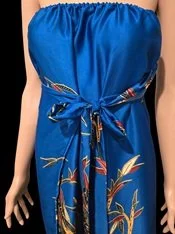 Woman wearing DONBERNAE blue floral sarong dress with elegant beach styling