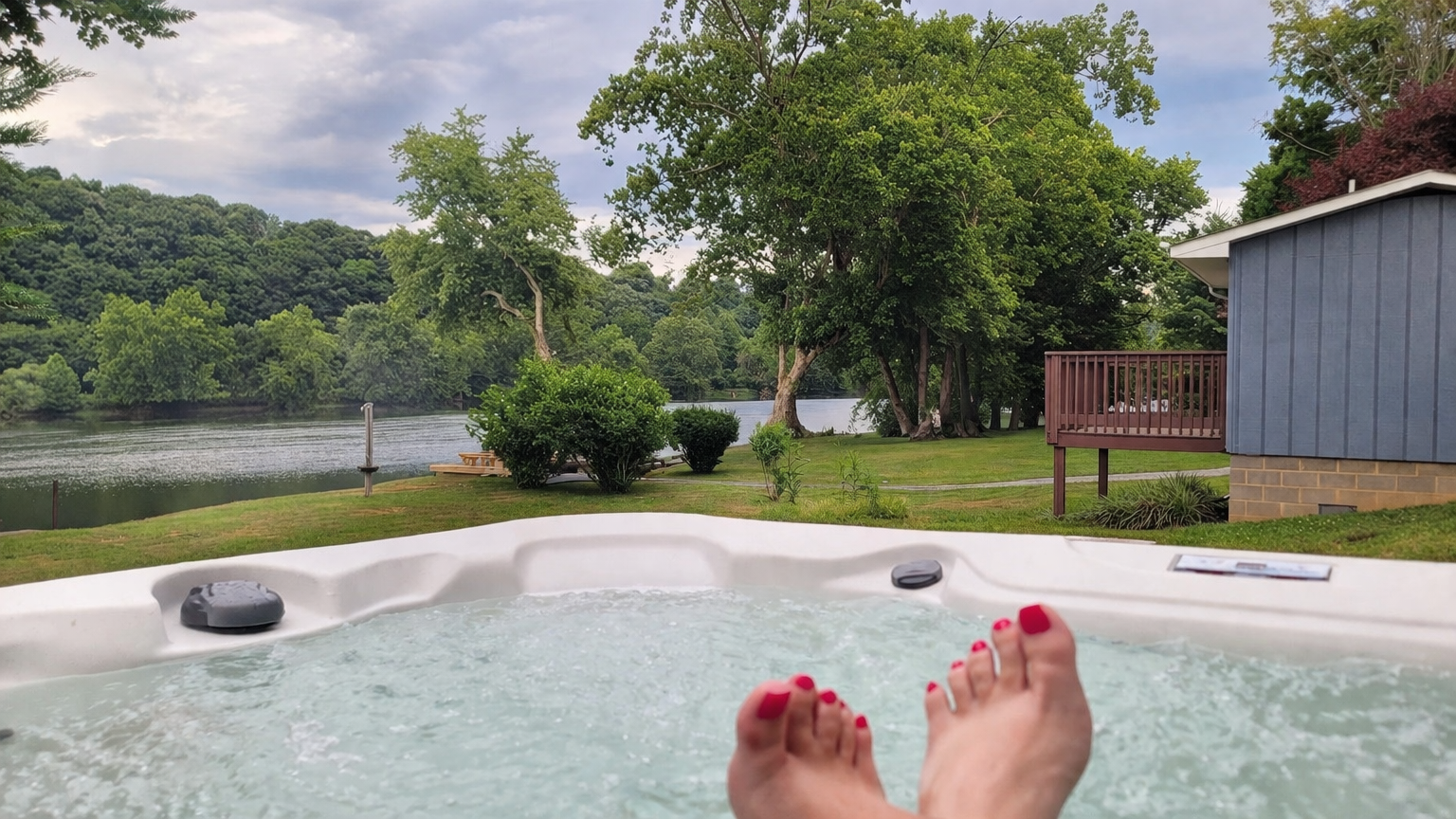 Relaxing in a private hot tub overlooking the New River at our riverfront vacation rental in Belspring, Virginia