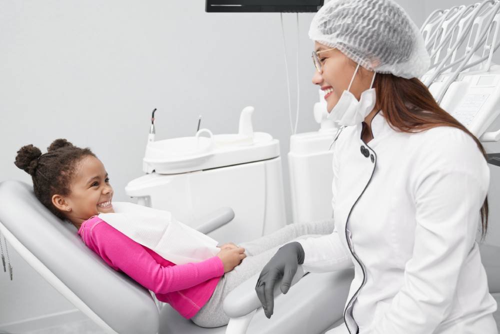 girl looking female dentist laughing clinic.jpg