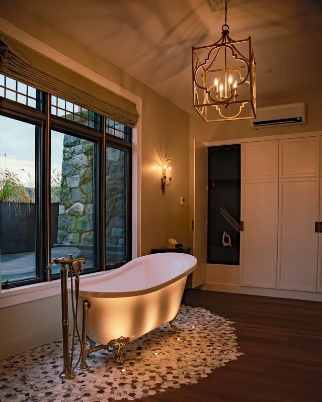 Lantern pendant, wall sconce and floor uplighting in a heritage character suite bathroom in Esquimalt