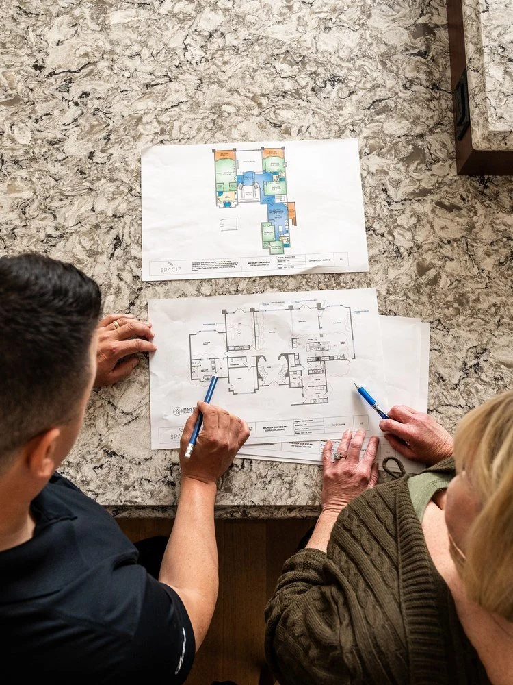 Grifflyn electrician and client reviewing building floor plans for an electrical planning report in Victoria