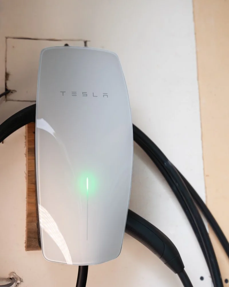 Tesla wall connector EV charger installed and running in a garage