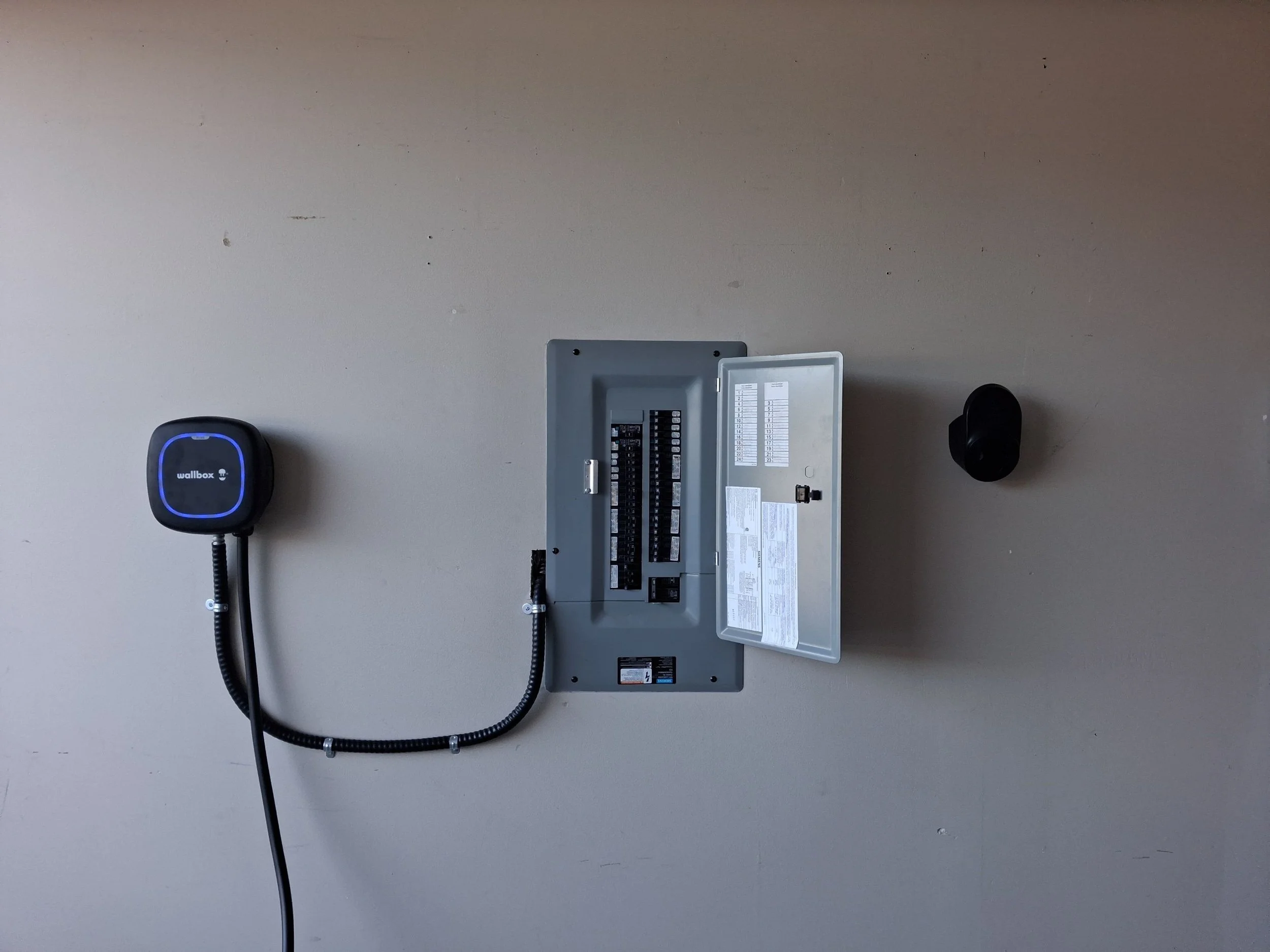 Wallbox Pulsar Plus Level 2 EV charger hardwired to a Siemens electrical panel in a Langford, BC garage, installed by Grifflyn Electric