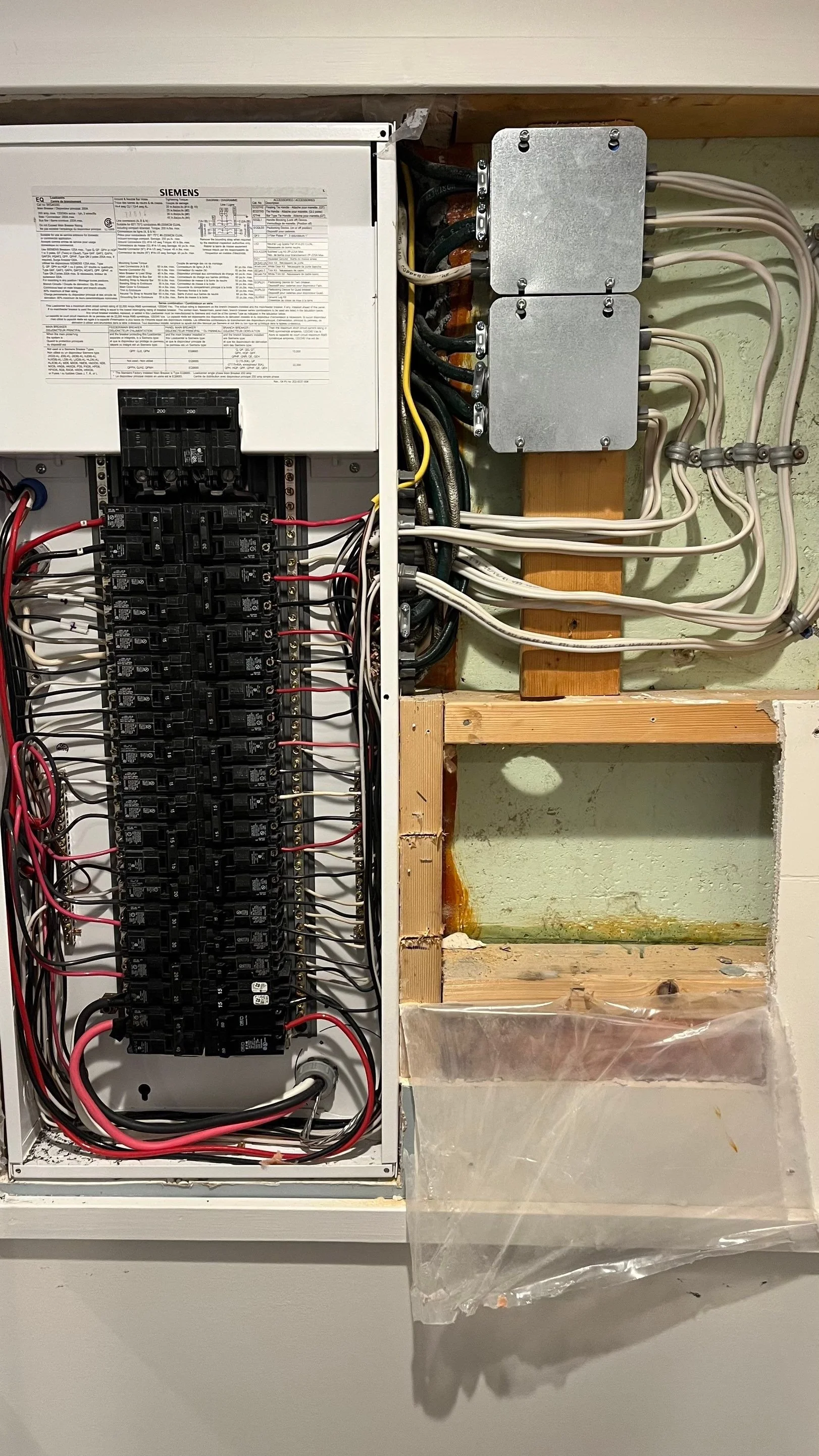 Full Siemens 200 amp panel with tandem breakers installed to free up space for a 2-pole 100A sauna feeder breaker