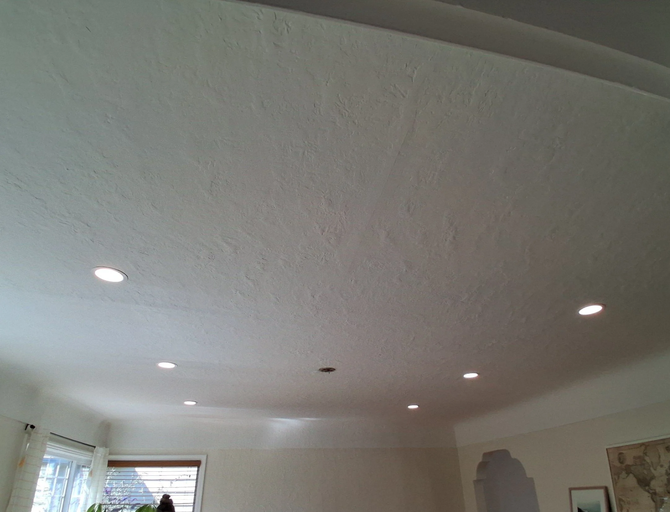 Finished recessed LED pot lights spaced evenly across a living room ceiling in Victoria, BC