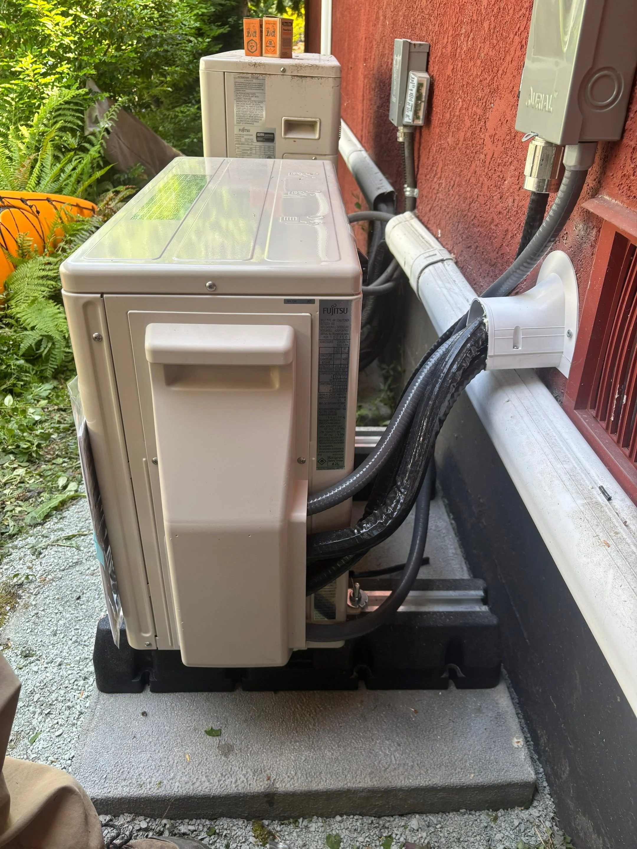 Completed heat pump and disconnect on a Victoria home exterior