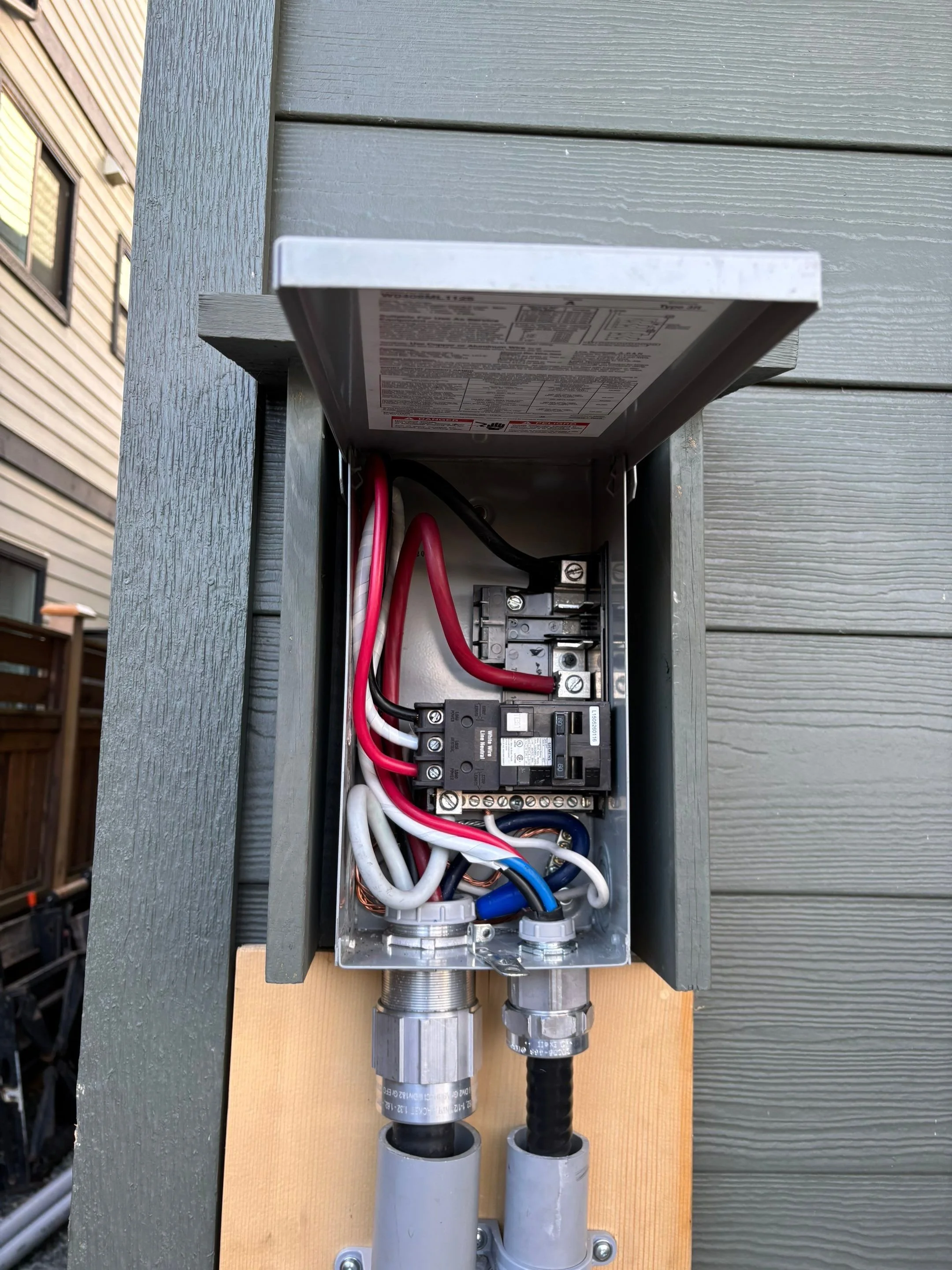 Open disconnect enclosure showing a 60 amp GFCI breaker wired for a residential hot tub