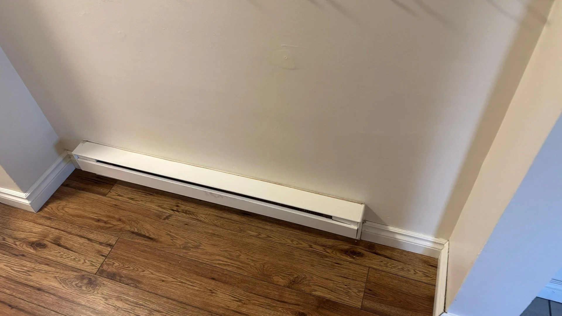 Electric baseboard heater installed along an entryway wall in a Victoria BC home