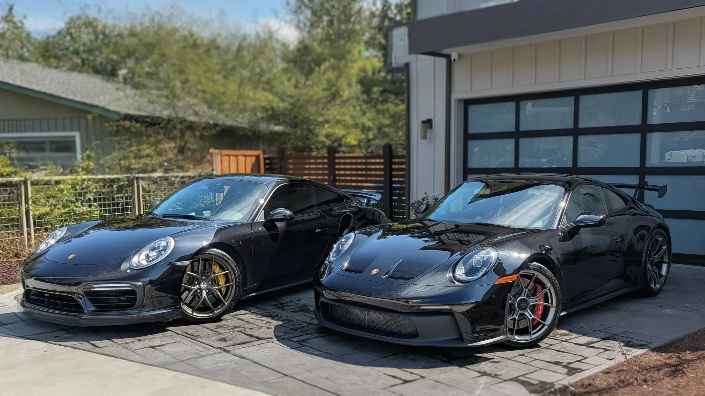 Two black Porsche sports cars detailed by french detail in santa cruz