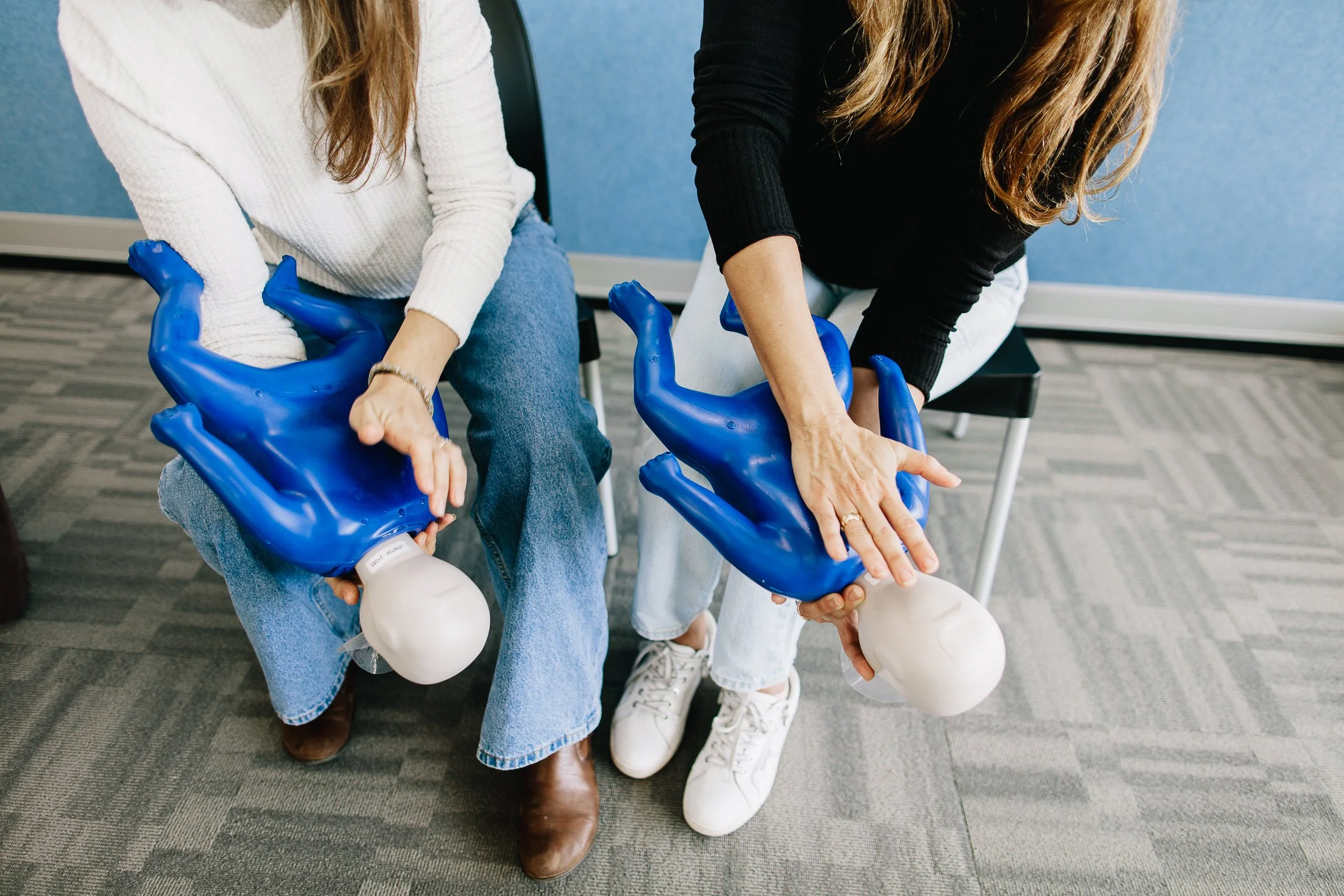 Back blows being performed to a baby manikin