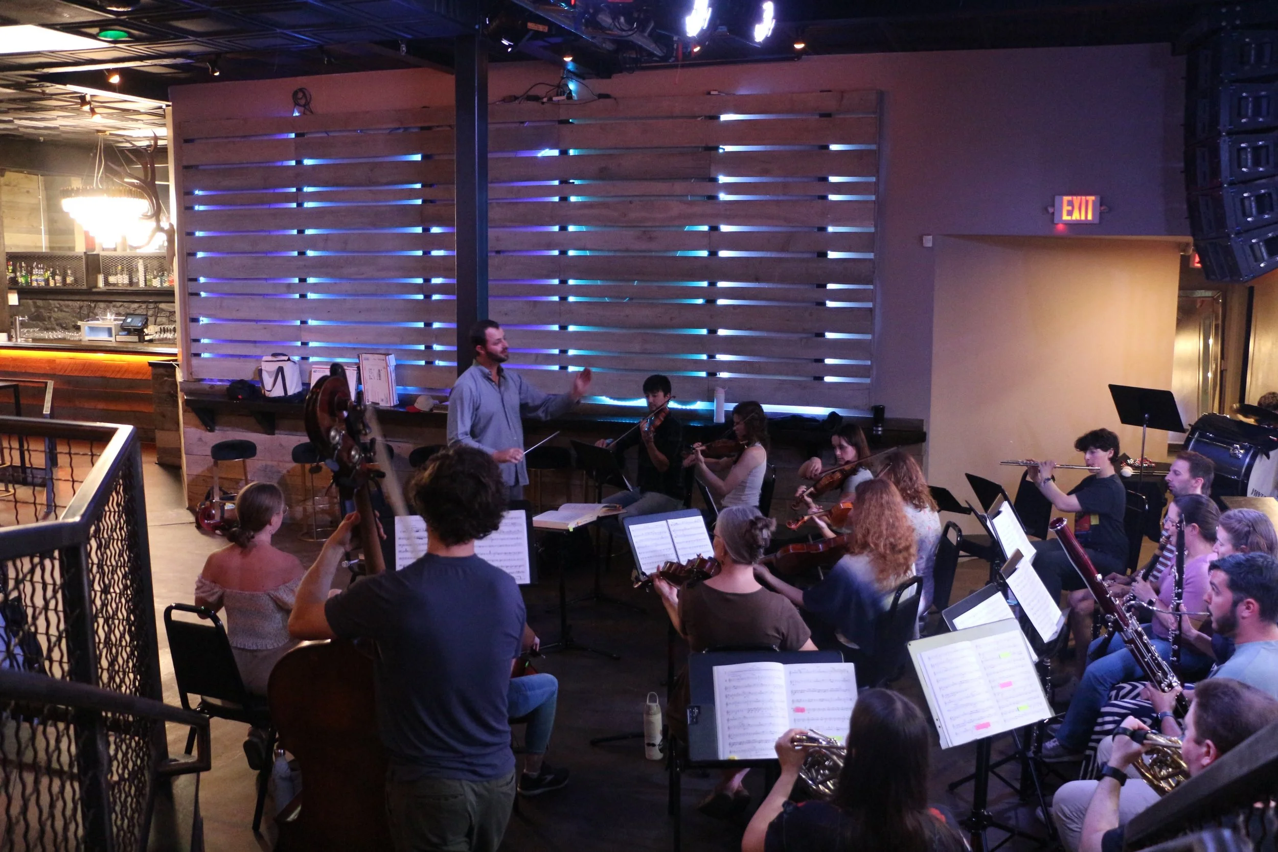 Ben conducts our orchestra at the sitzprobe rehearsal at Premiere PC.