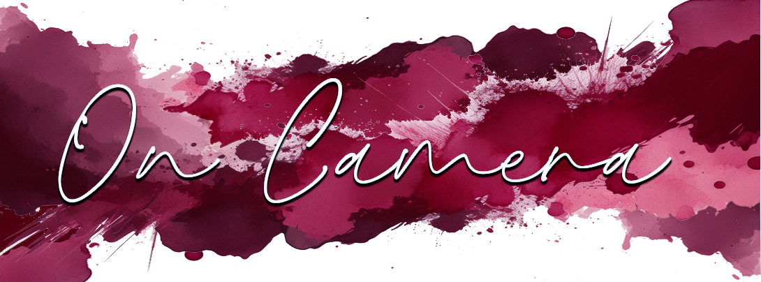 A digital graphic with watercolor splash background in shades of pink, purple, and burgundy, with the text 'On Camera' in cursive white font.