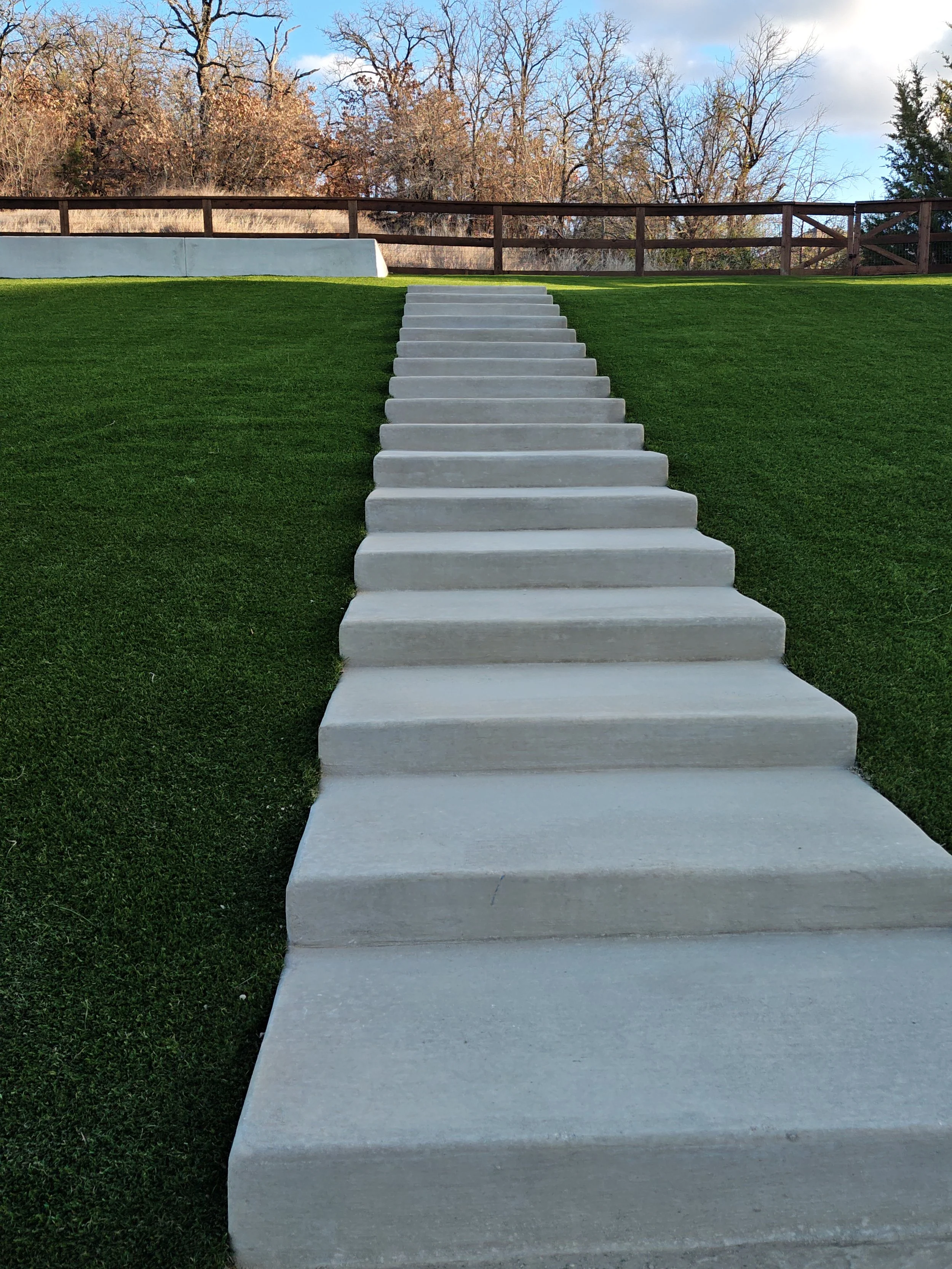 Modern concrete walkway and artificial grass installation in North Texas
