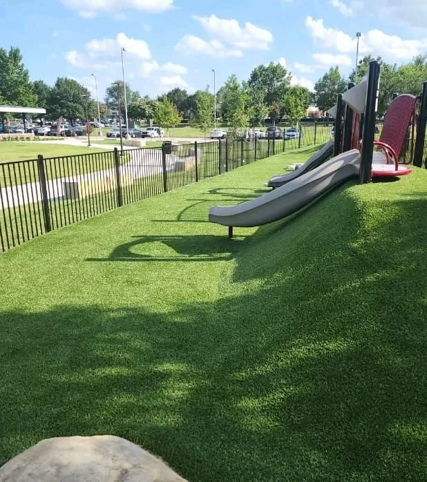 Artificial turf under a playground slide and play structure in DFW