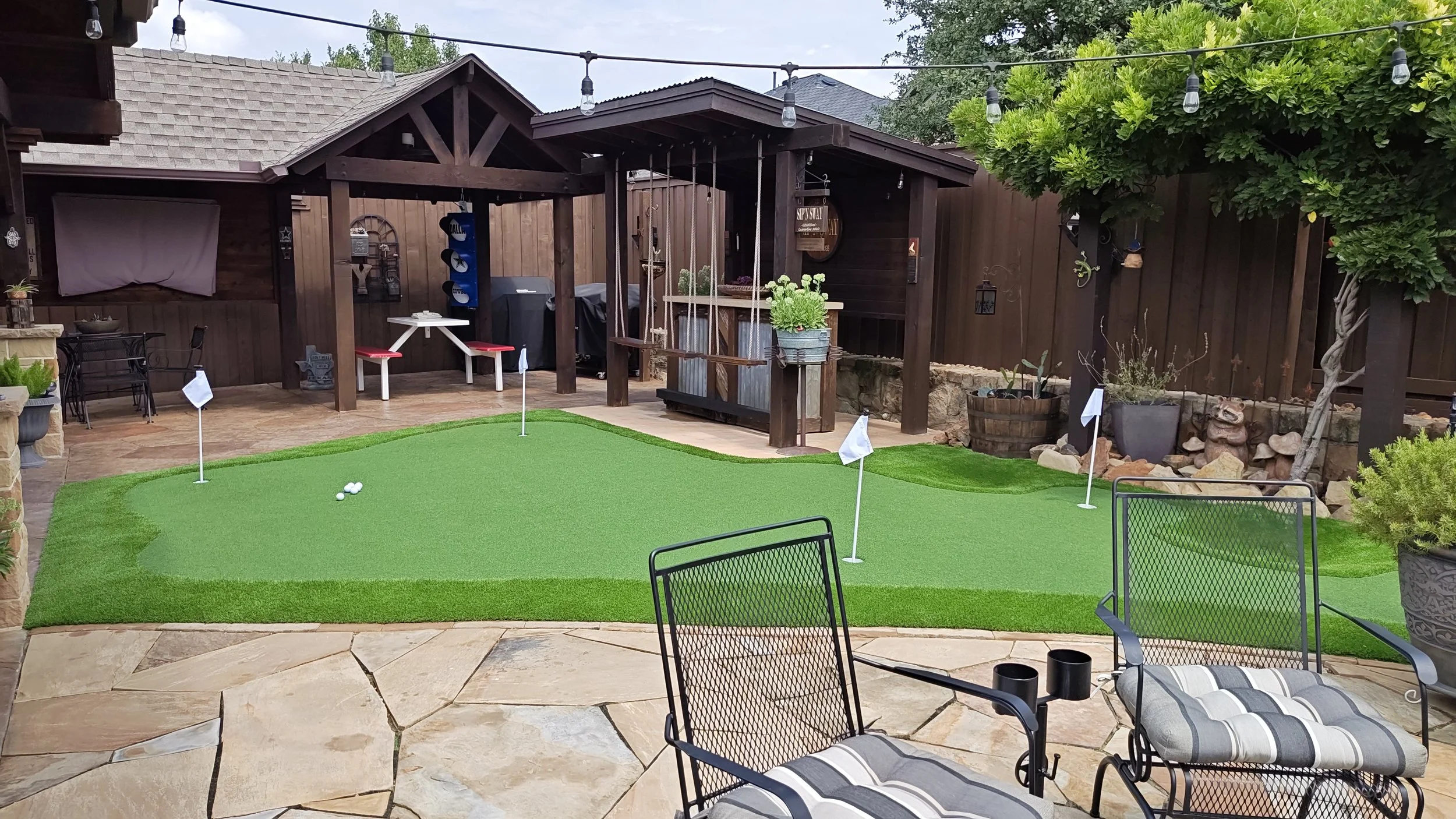 Custom backyard putting green installation in Dallas-Fort Worth with professional-grade synthetic turf and integrated outdoor lighting