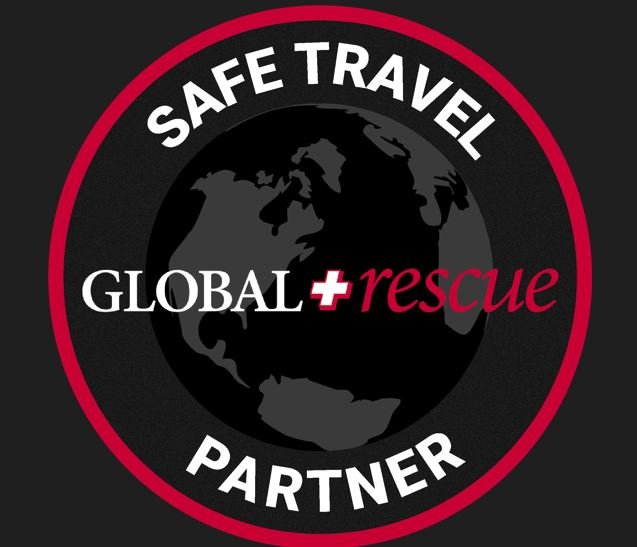 Logo with a black globe in the center, surrounded by a red circle. Text reads 'Safe Travel Partner' at the top, 'Global Rescue' in the middle, and 'Partner' at the bottom. The word 'rescue' is in red, and the other text is in white.