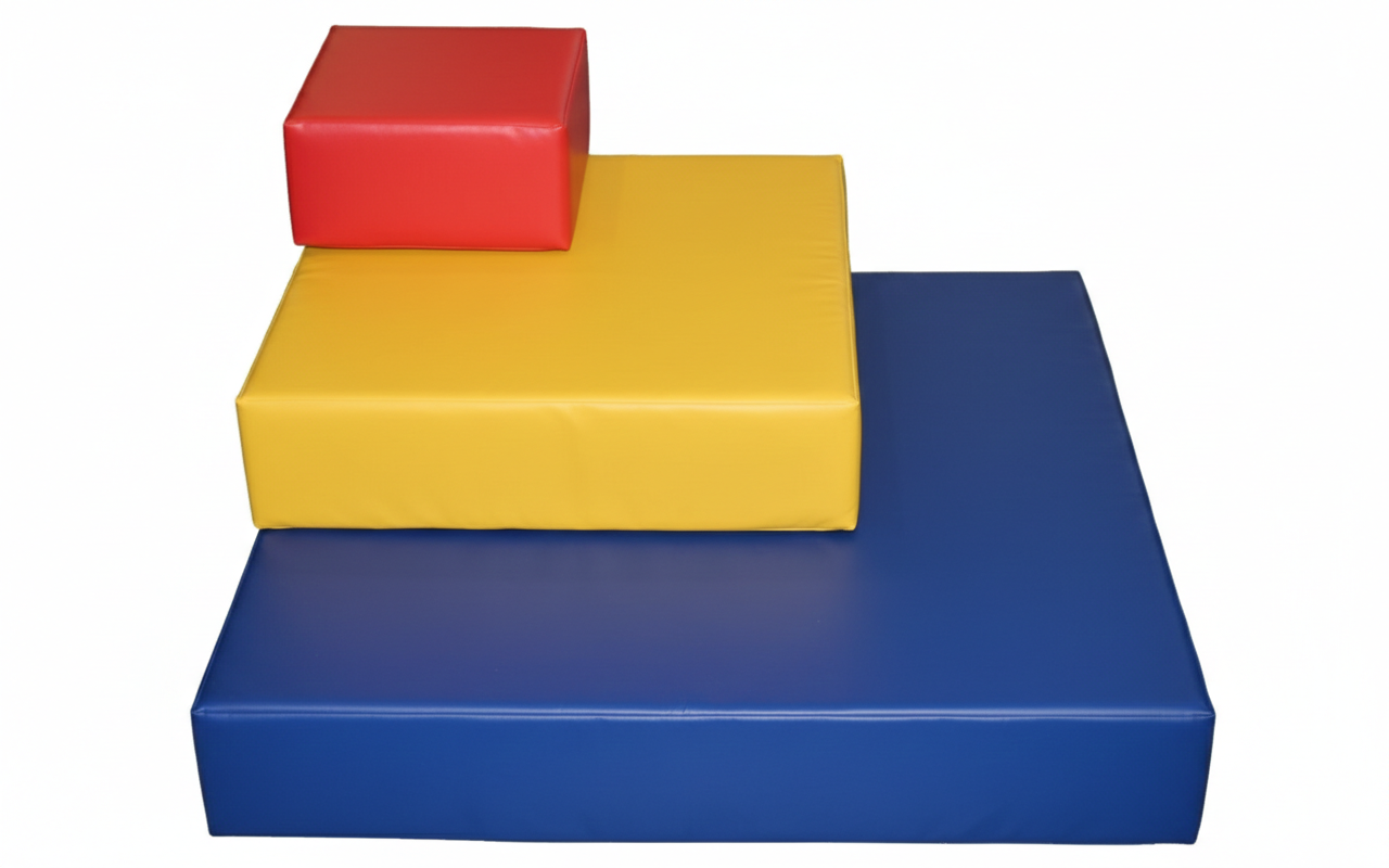Stacked colored foam blocks in red, yellow, and blue, arranged on a white background.
