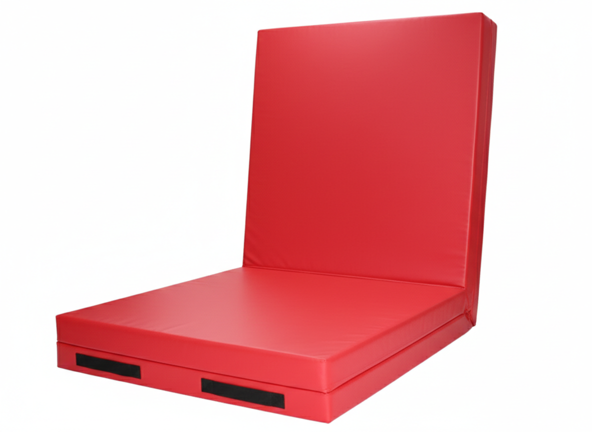 Red wrestling mat with high shock-absorbing padding.