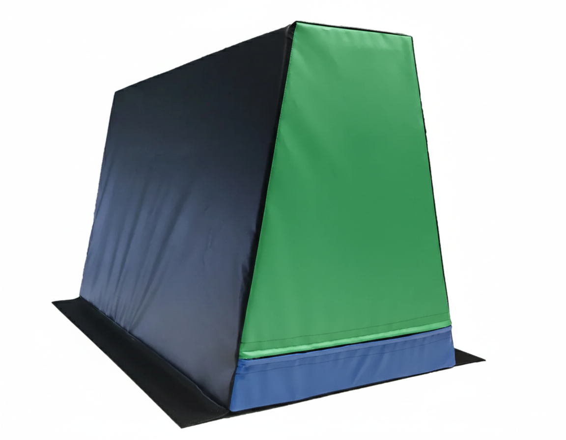 A padded foam climbing or gymnastics wedge with blue, green, and black sections.