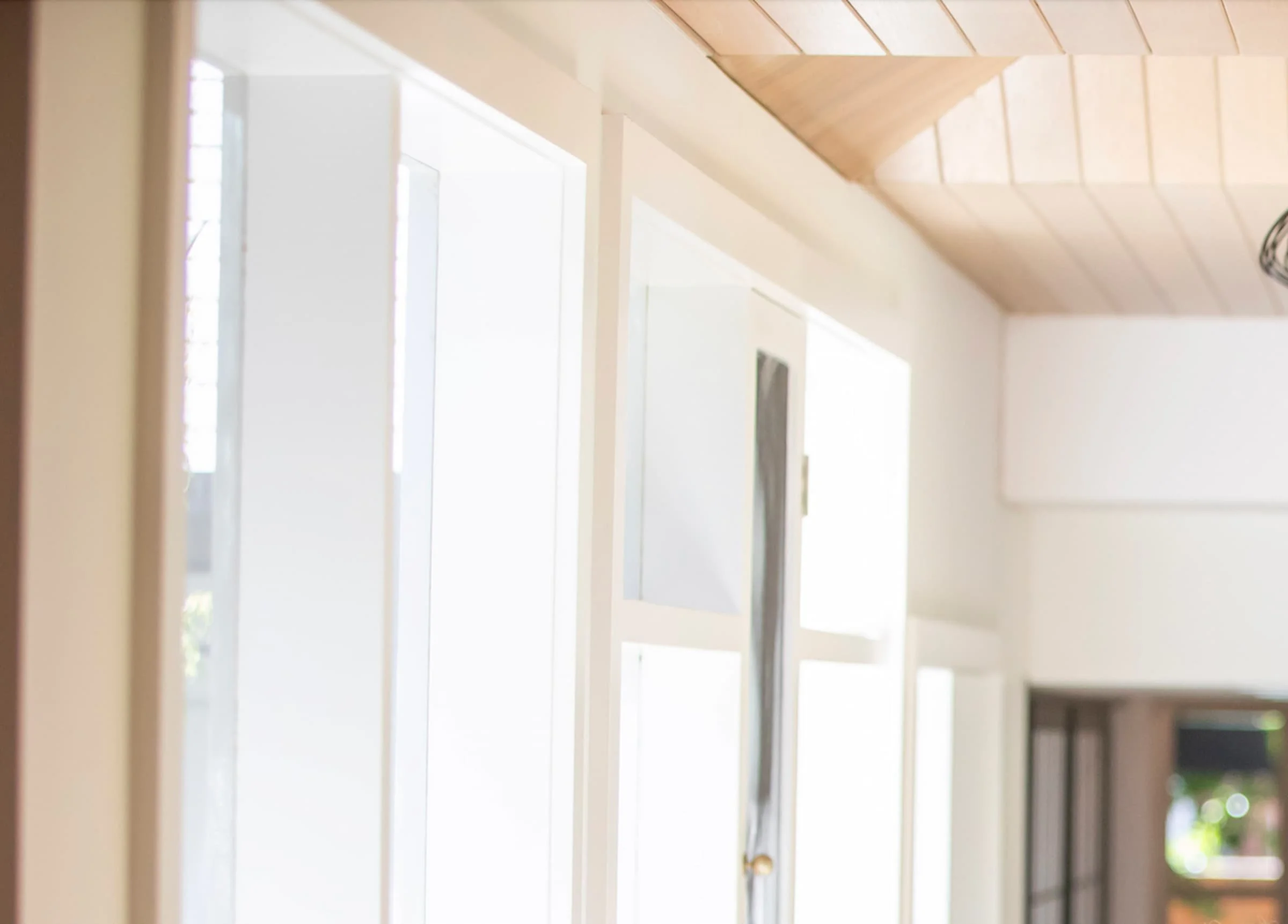 Orium & Co founders Lisa and Damien smiling together inside a light-filled Melbourne home.