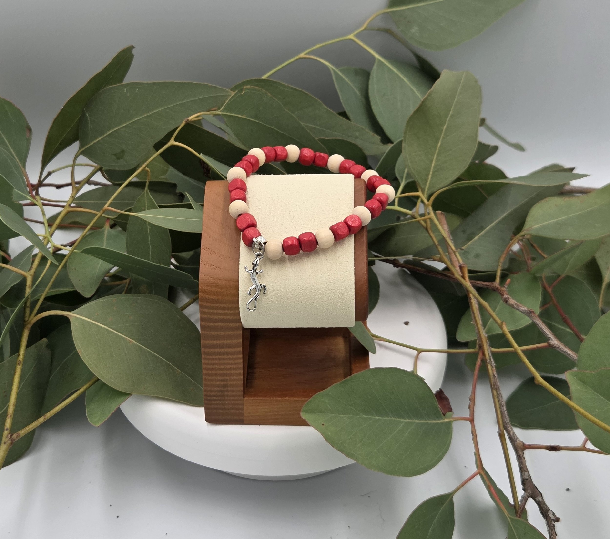 OOAK red and cream wood bead bracelet with silver tree goanna charm on gum leaves.