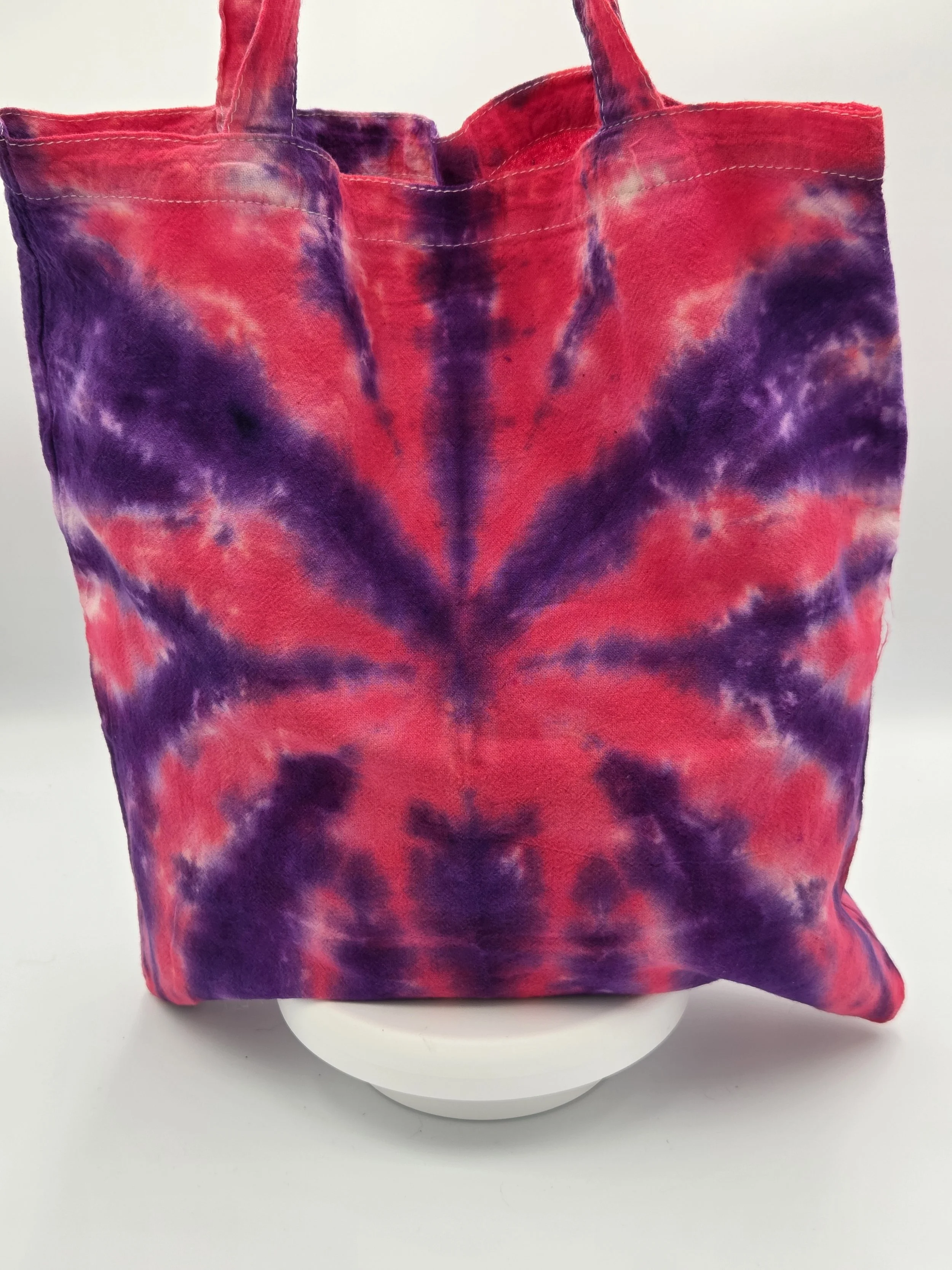 Hand-dyed cotton tote bag with a sharp purple and raspberry spider design. OOAK textile art handmade in Canberra by Livity Studio.