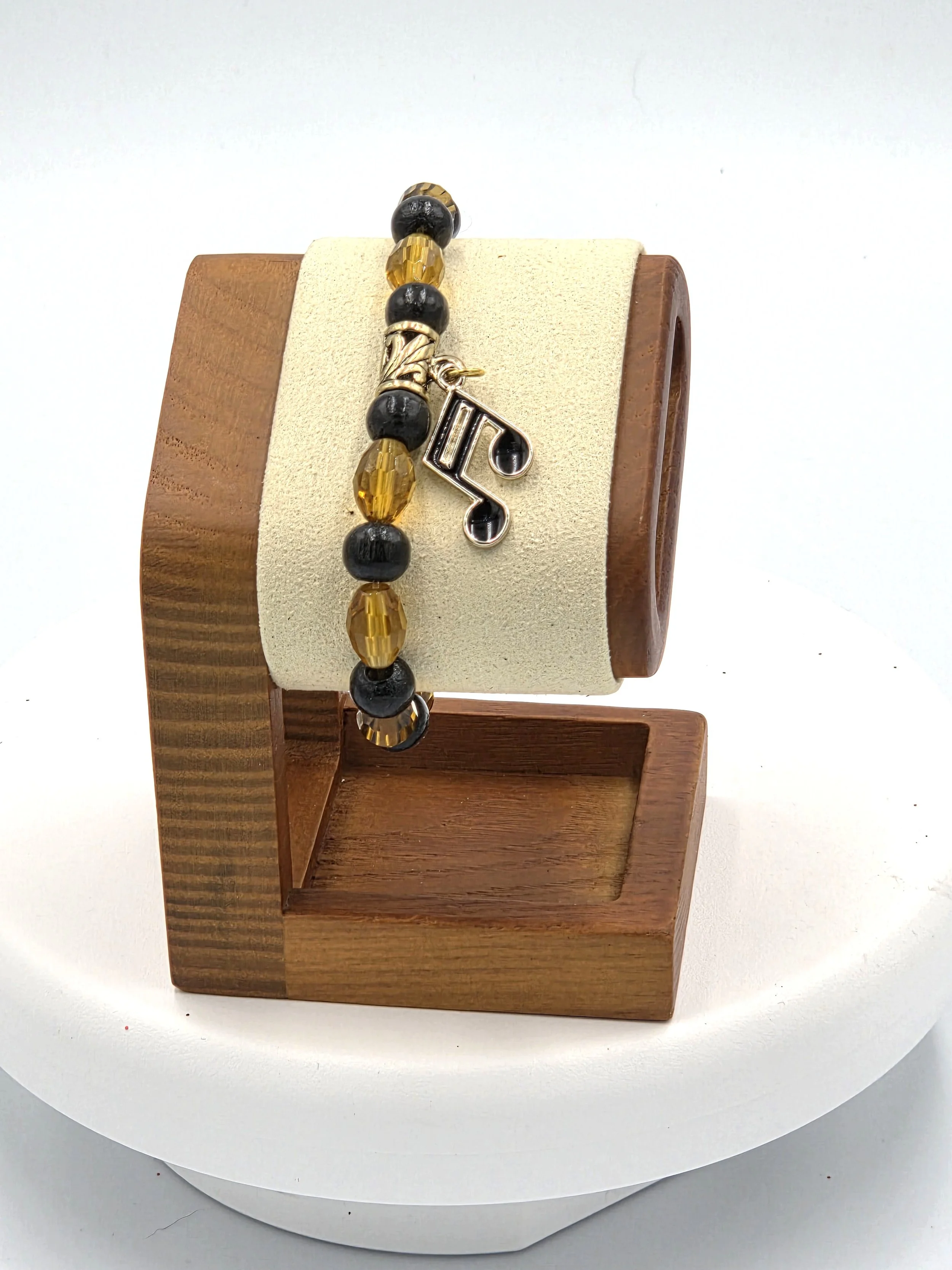 OOAK amber glass and black wood bracelet with gold & black musical note charm.