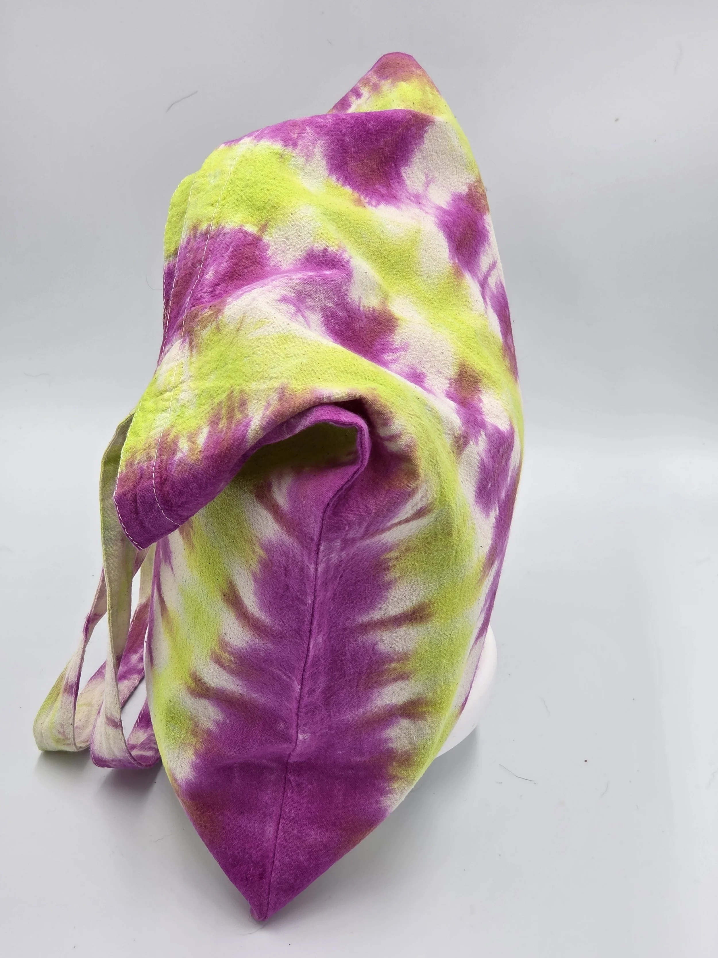 An upright, dimensional calico tote bag showcasing a vertical tie-dye pattern of rich fuchsia columns and bright lime green channels with hints of white.