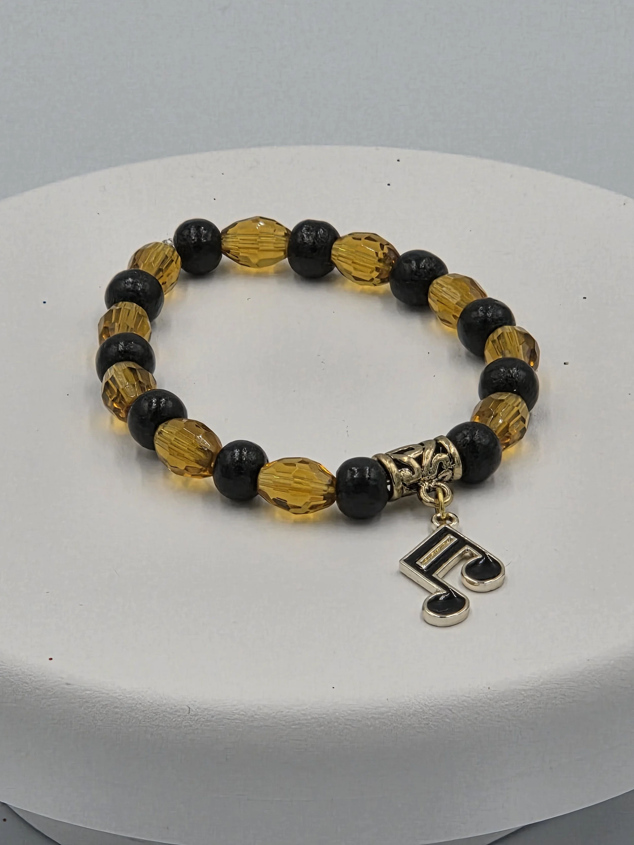 OOAK amber glass and black wood bracelet with gold & black musical note charm.